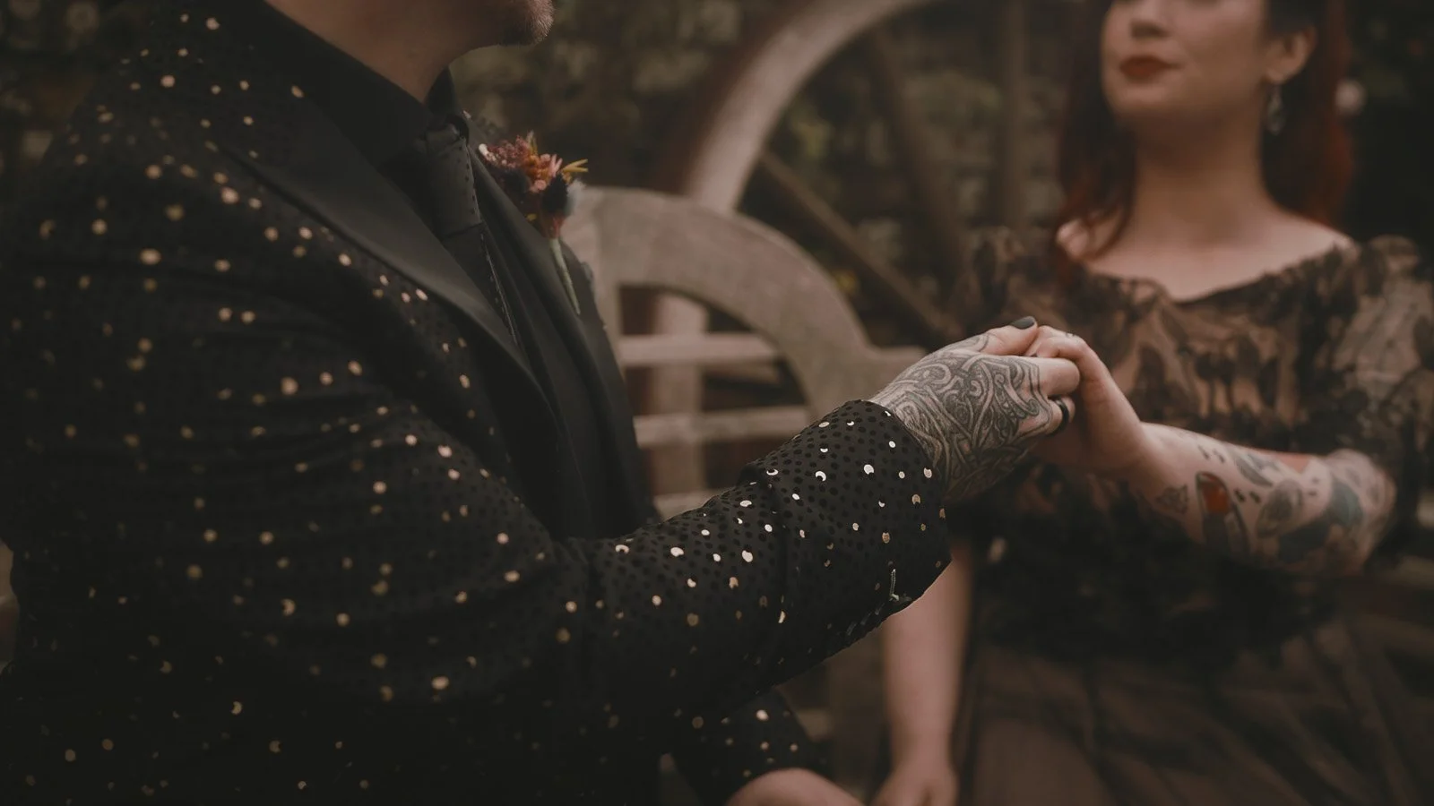 Close-up of wedding ring exchange with alternative styling and black nail polish