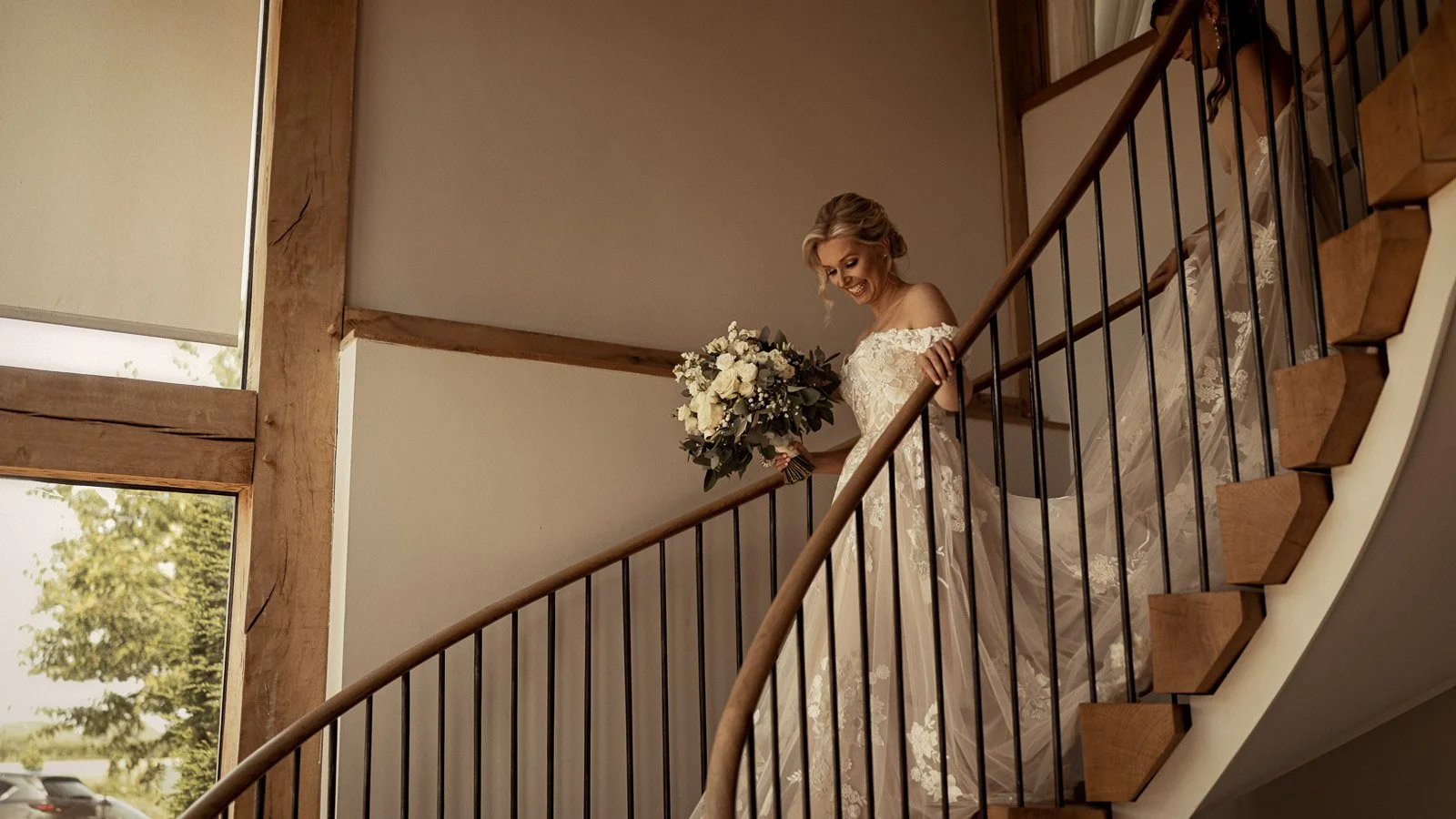 Editorial bridal portrait at Cooling Castle Barn wedding venue as the bride stands on the staircase.
