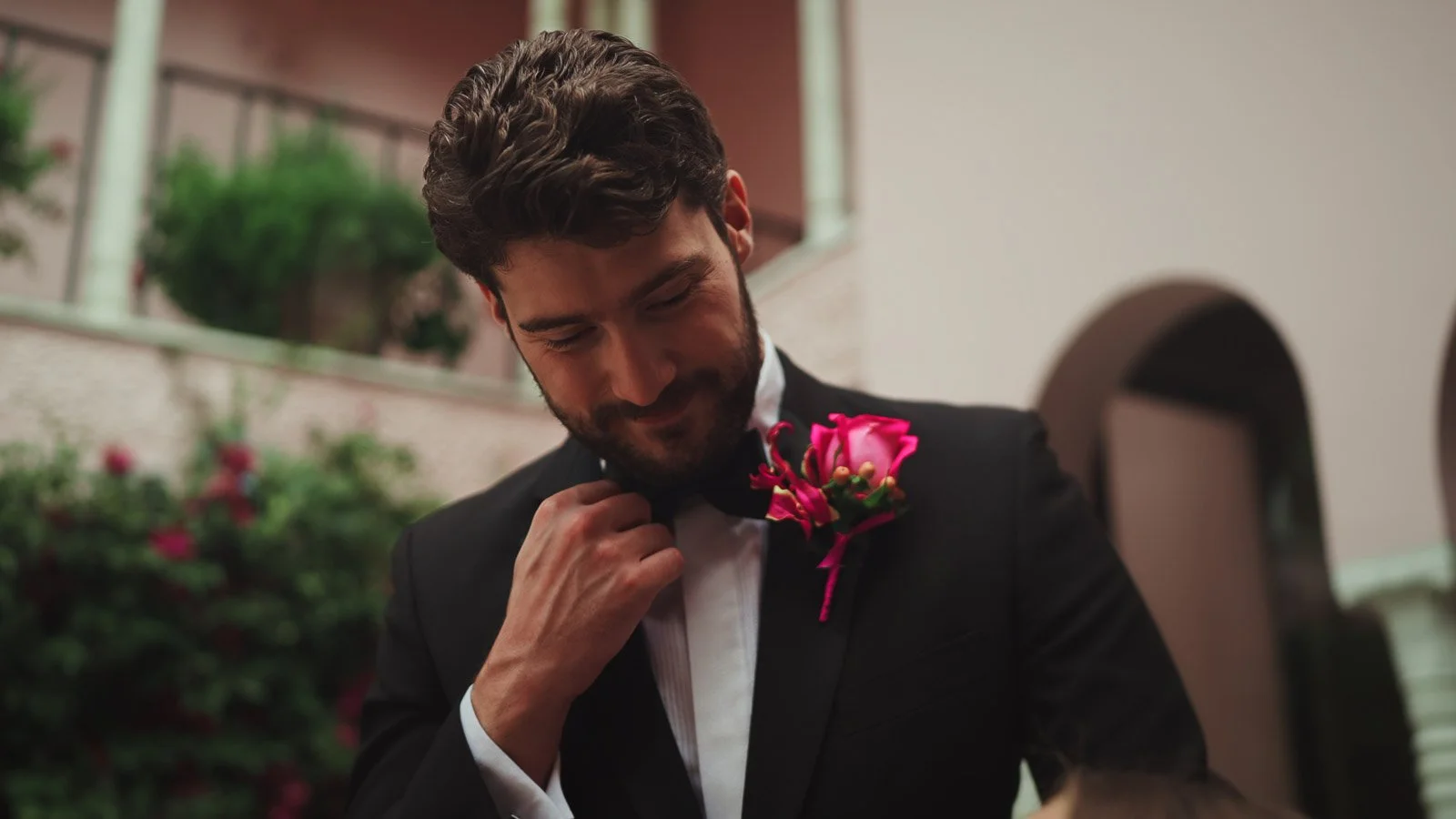 Groom in classic black tie, refined editorial portrait from a fine art wedding film.