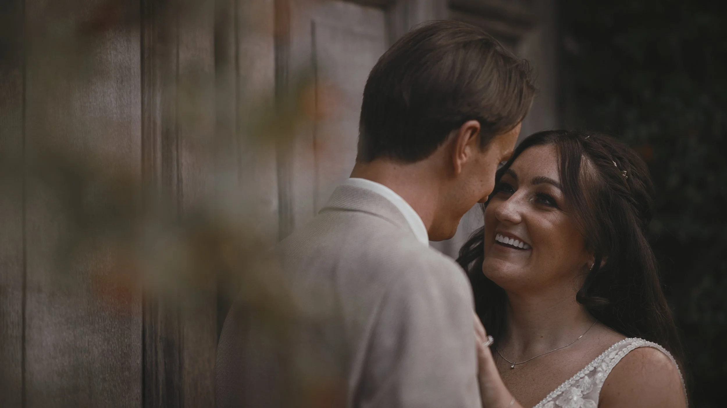 Close up shot of a brides face as she smiles at her groom during a Winters Barns wedding film.