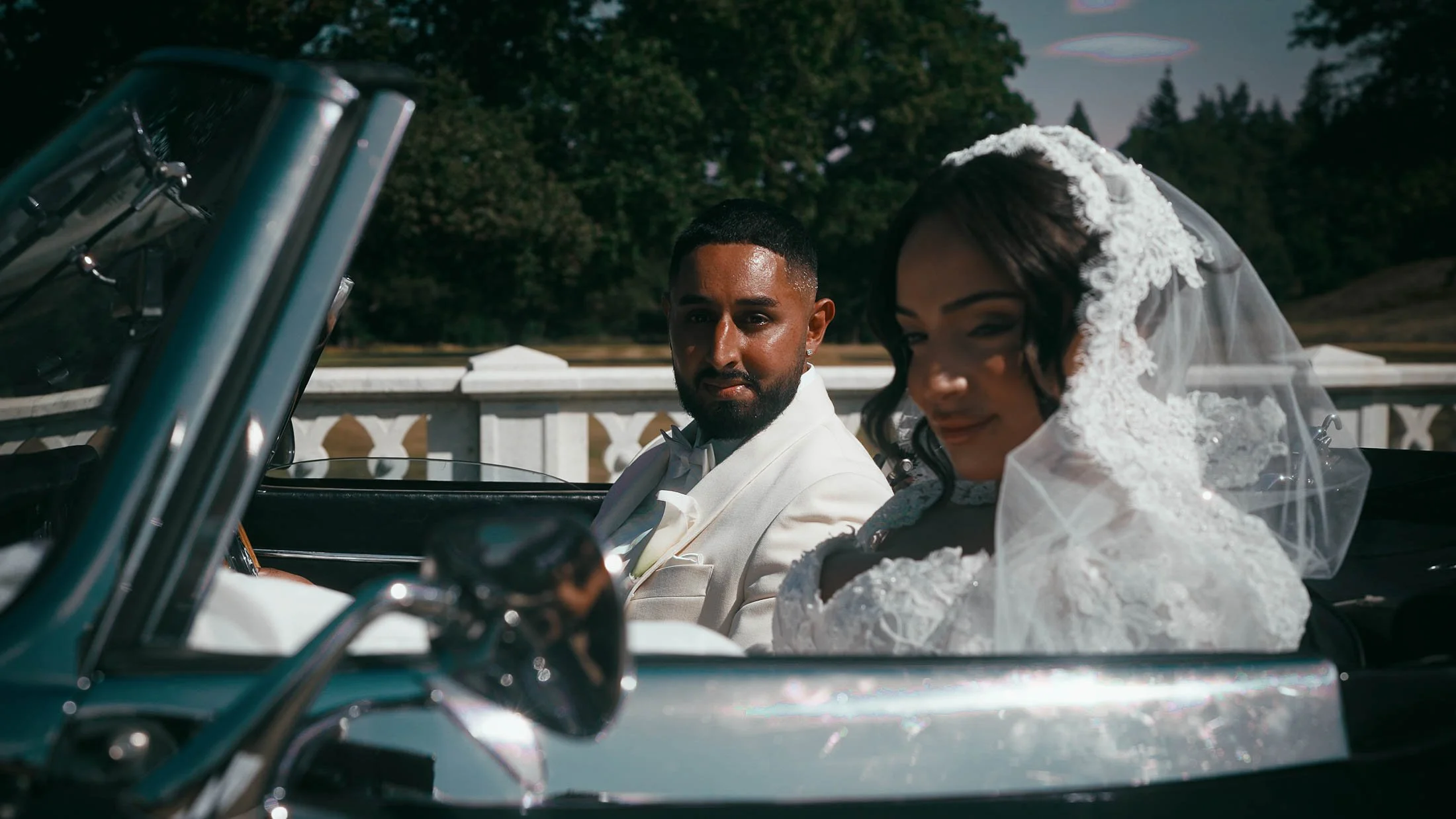 bride and groom in a luxury sports car during their destination wedding day.