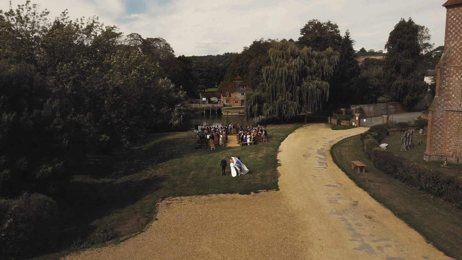 Editorial-style wedding photography from a colourful riverside celebration with bold florals and a marquee reception.