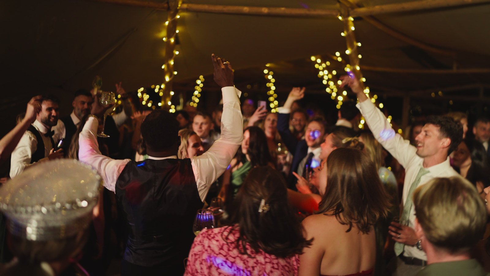 Guests and atmosphere from a colourful riverside wedding with black-tie styling and a marquee party on the Thames.