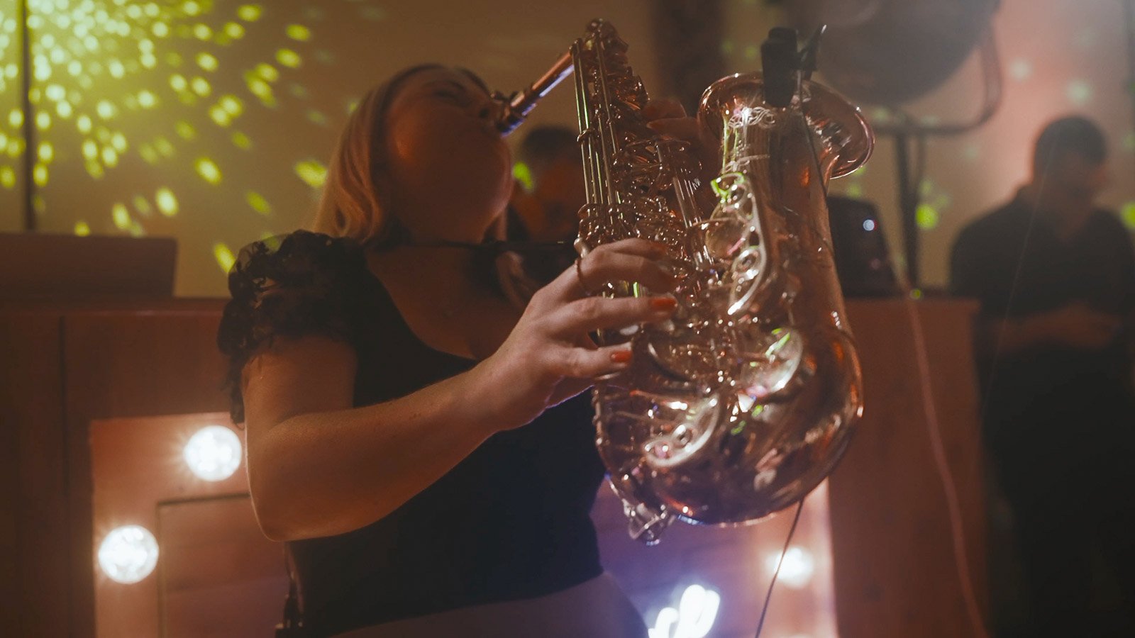 A Saxophone player leads the celebrations on the dance floor in a high-energy moment in a Winters Barns wedding film.