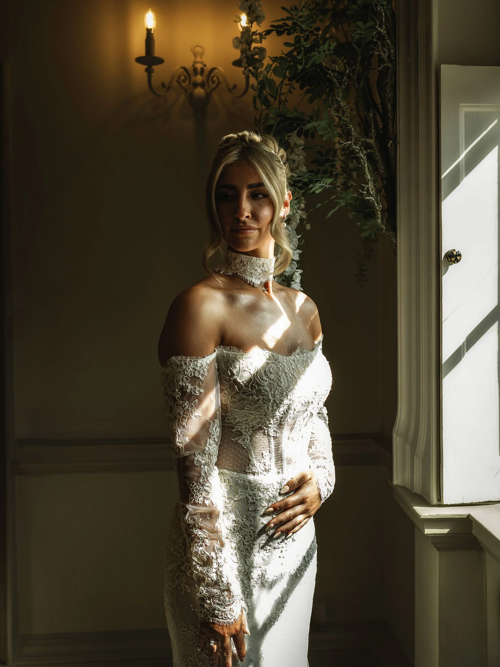 A bride poses in an editorial fashion for a portrait in the Wisteria Suite during bridal preparations at The Orangery Maidstone.