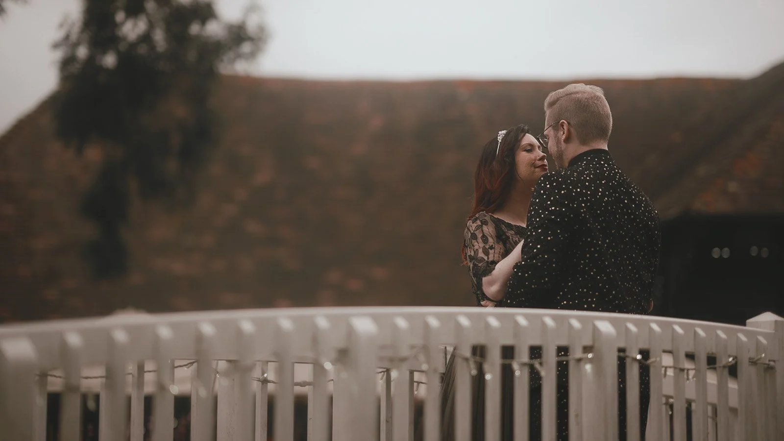 Alternative wedding couple laughing together in the courtyard at Winters Barns