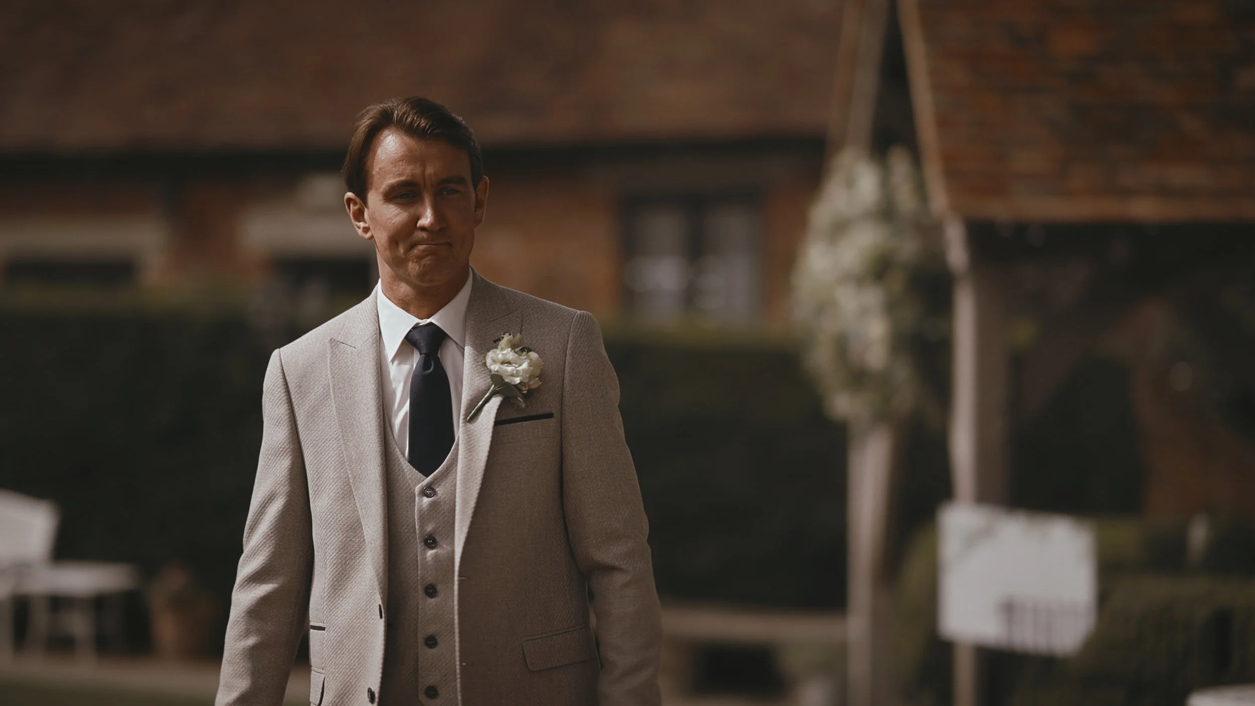 The groom walks towards an outdoor wedding ceremony at Winters Barns.