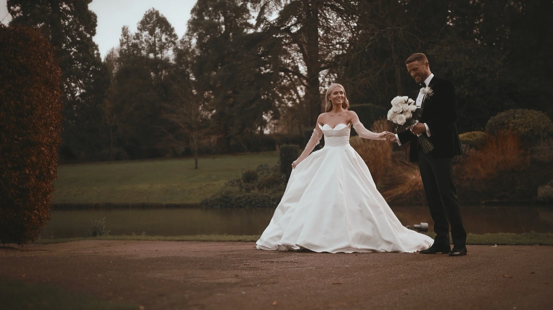 Bride and groom walking through The Orangery Maidstone during a New Year’s Eve black-tie wedding
