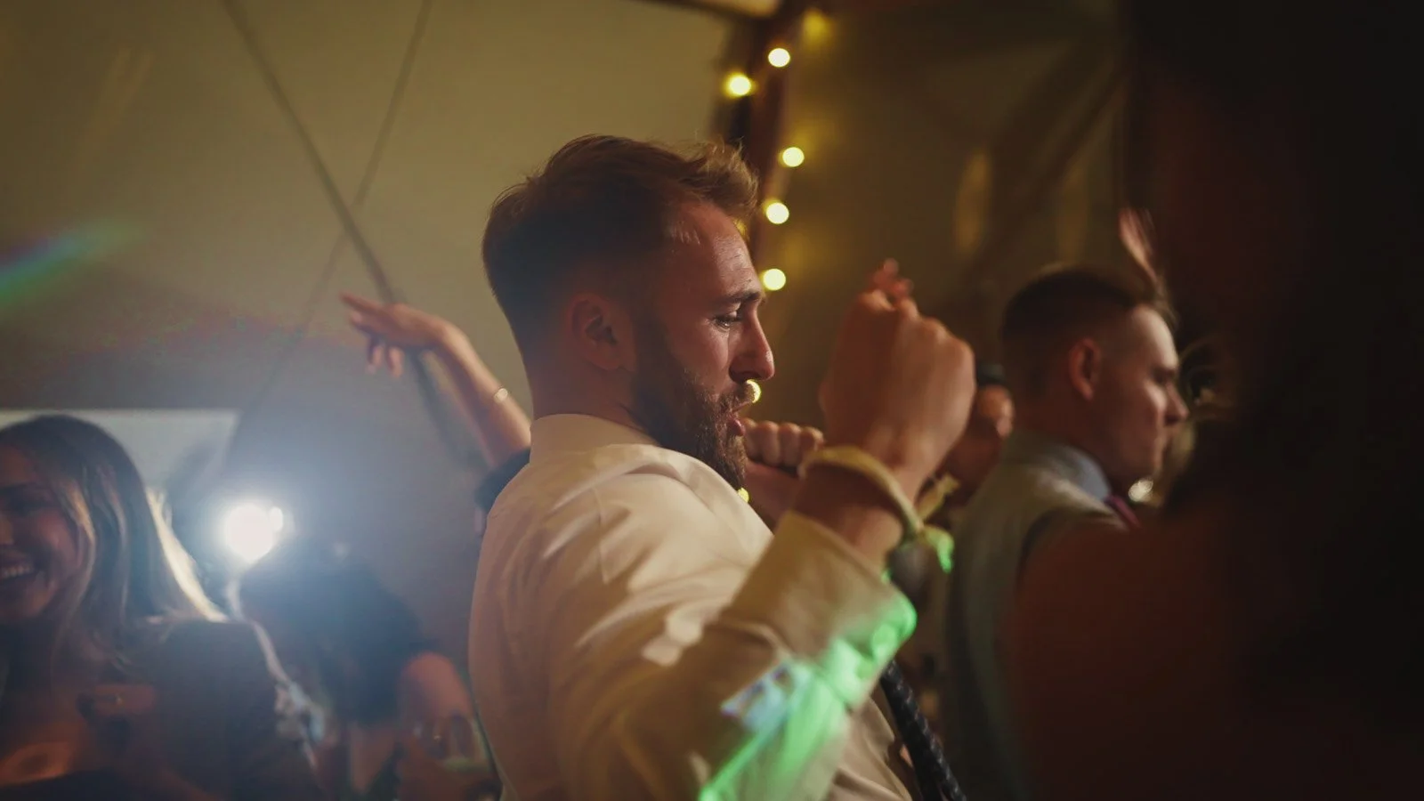 Editorial-style wedding photography from a colourful riverside celebration with bold florals and a marquee reception.