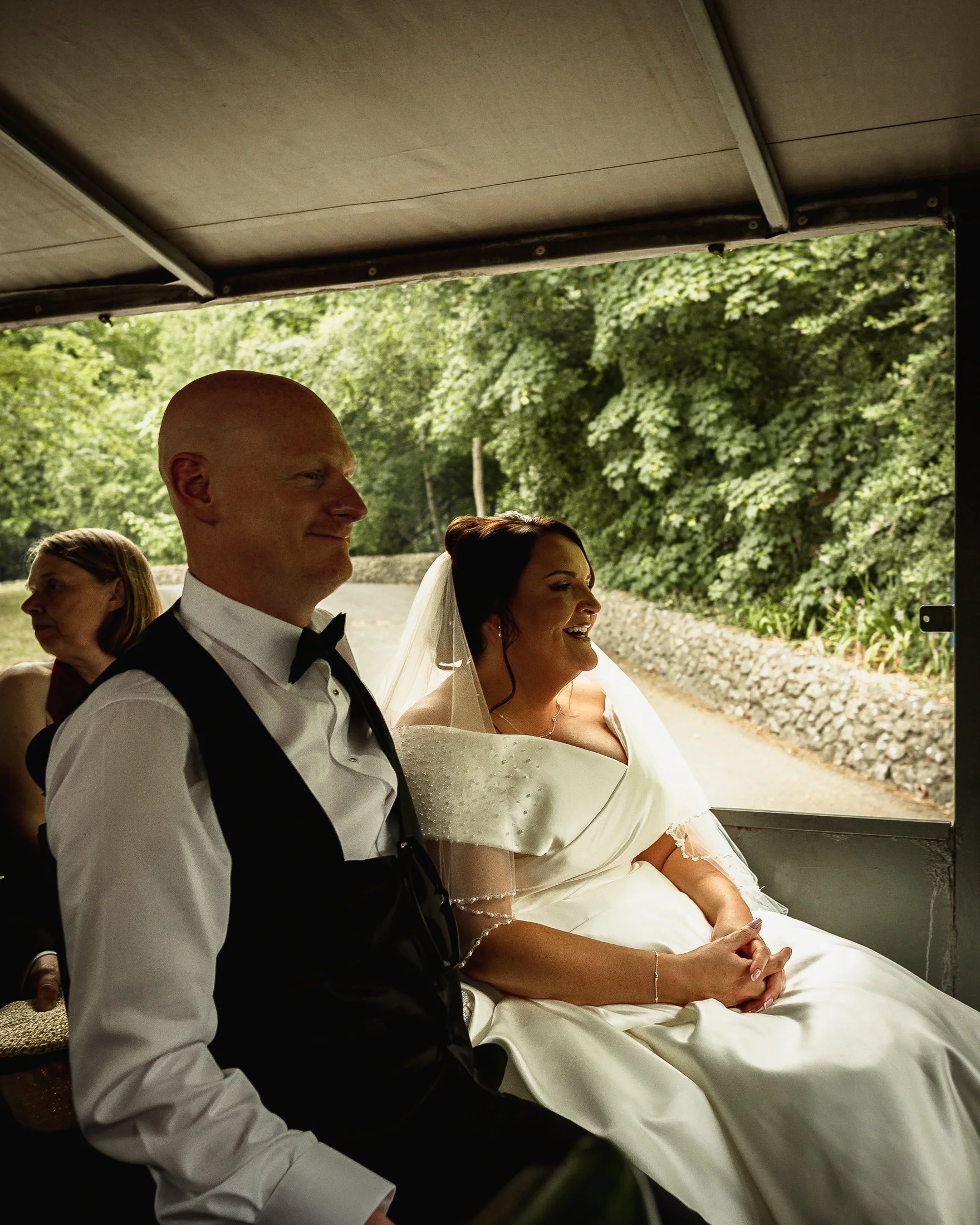 Bride and groom ride in a truck on safari at Port Lympne wedding.