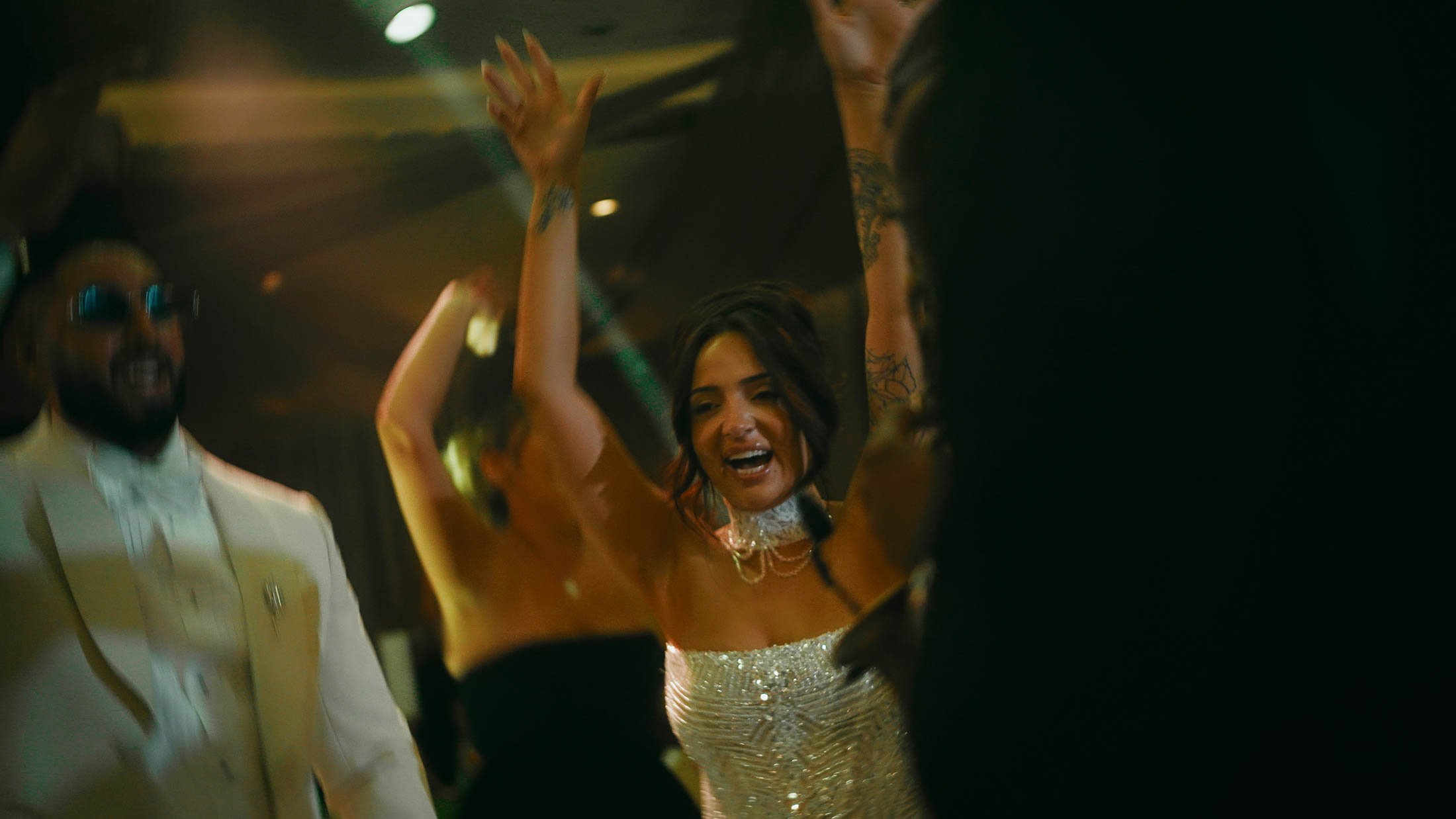 A bride dances energetically during her wedding after party at Grantley Hall.