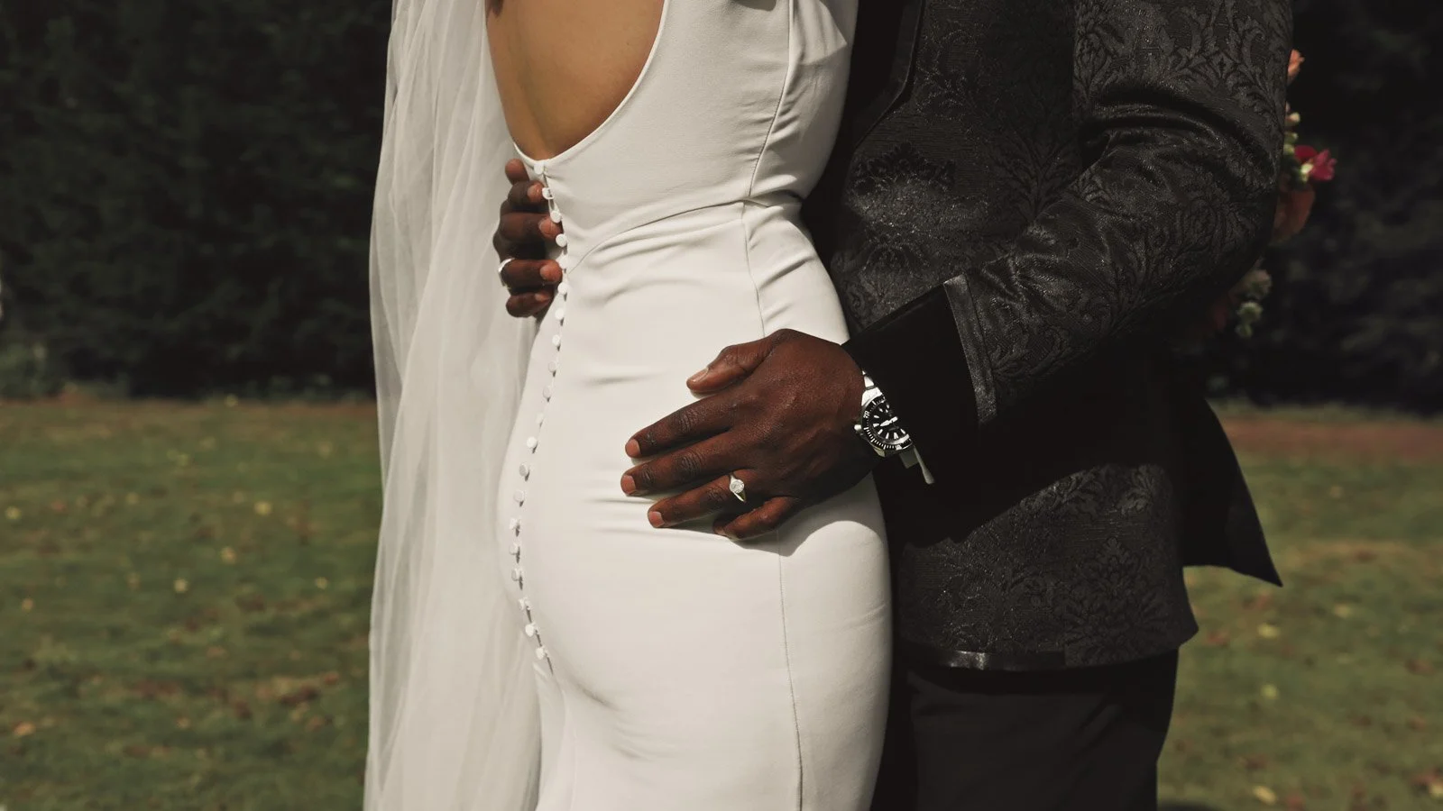 Editorial-style wedding photography from a colourful riverside celebration with bold florals and a marquee reception.