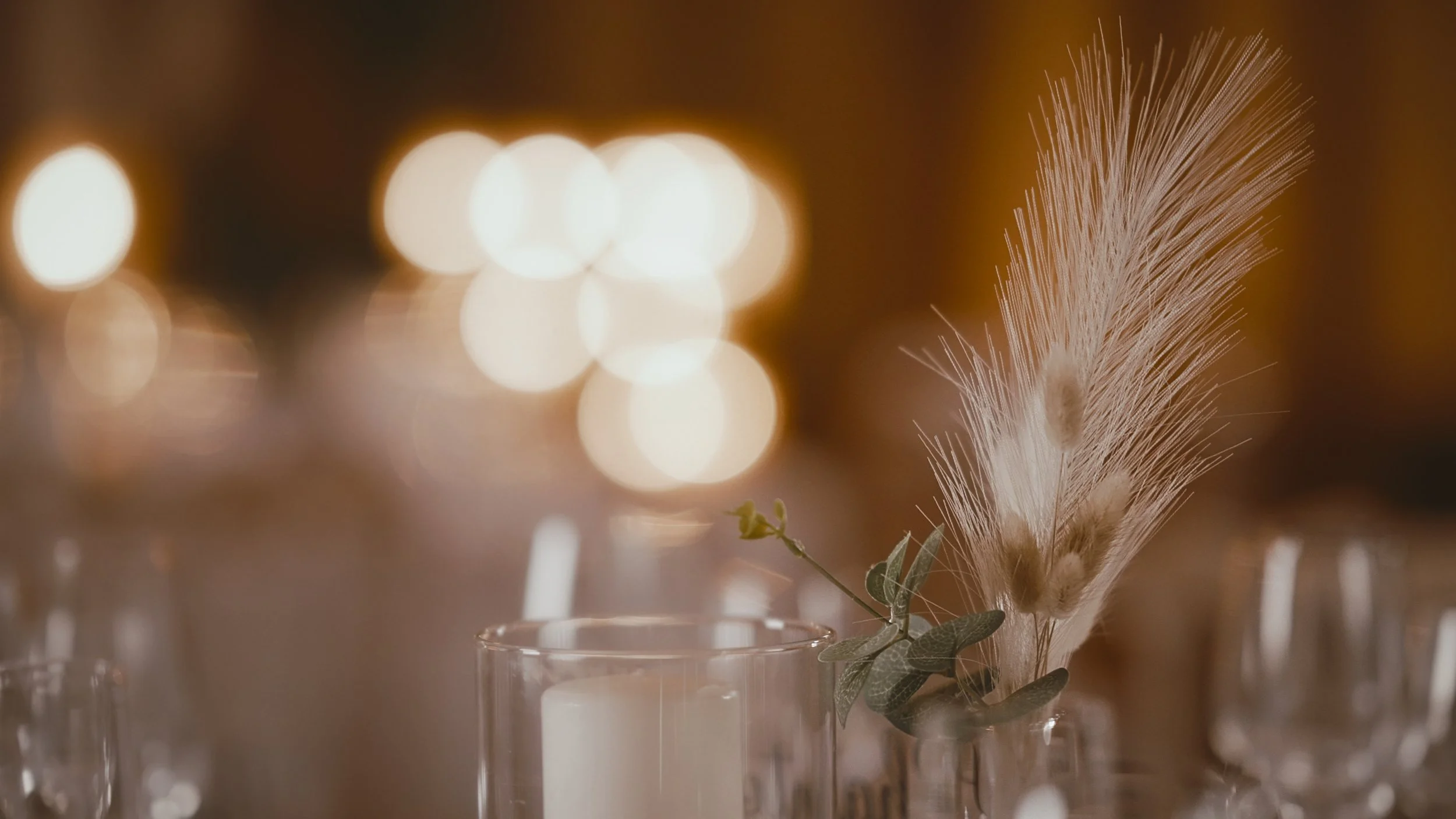 A close up details shot of pampas grass and table centres at a Winters Barns wedding reception.