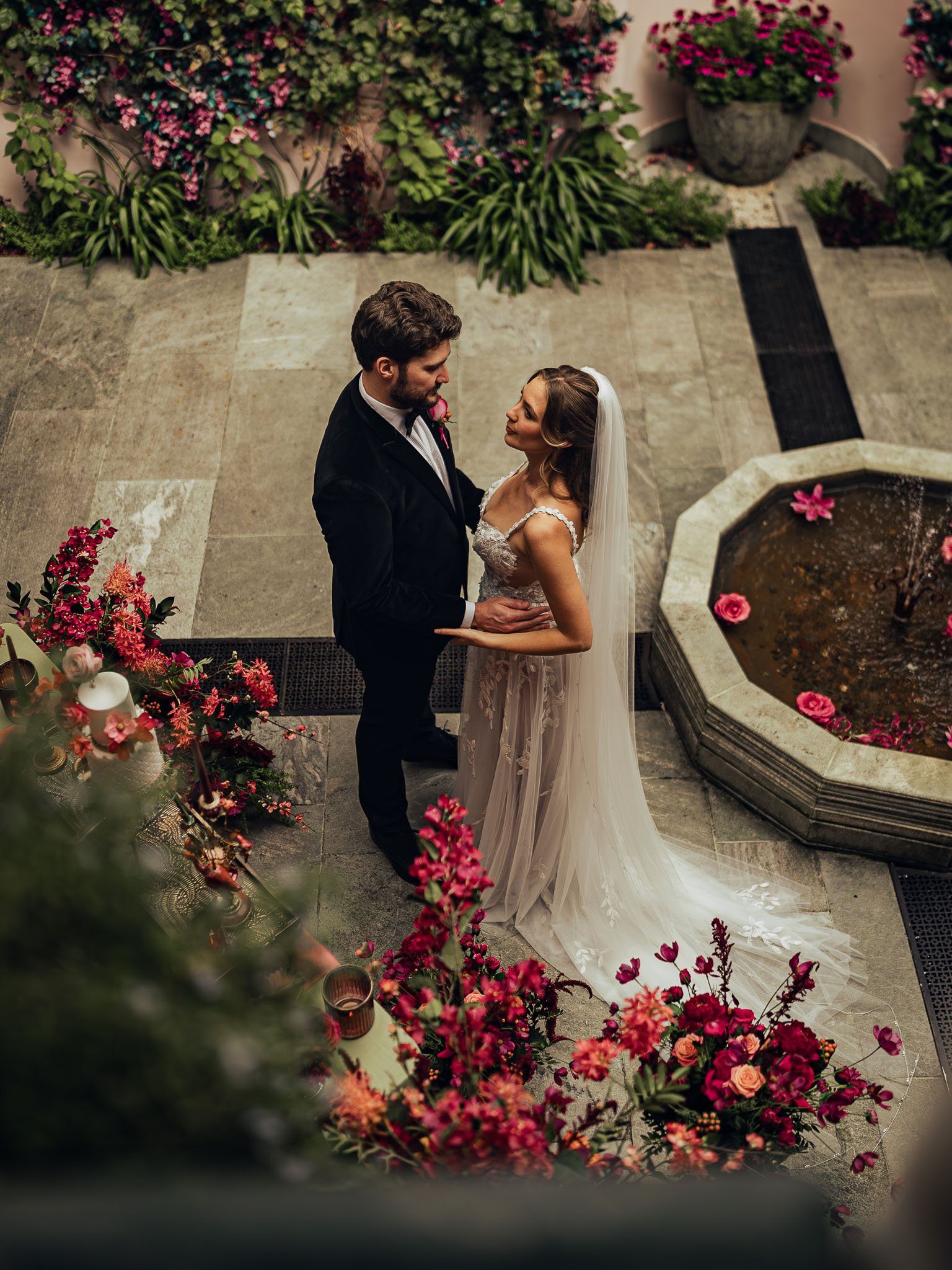 A couple share their first dance in a pink-themed wedding in the Moroccan Courtyard at Port lympne Hotel & Reserve