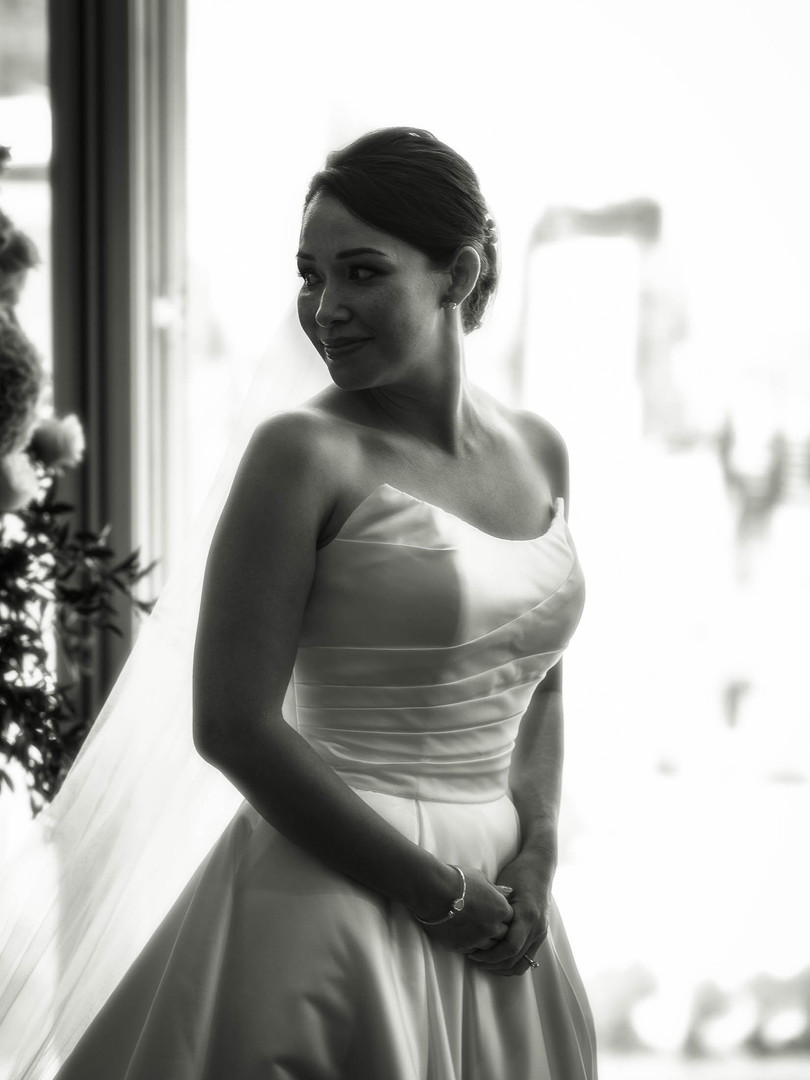 A timeless black and white portrait of a bride smiling during her indoor London wedding at The Shard.