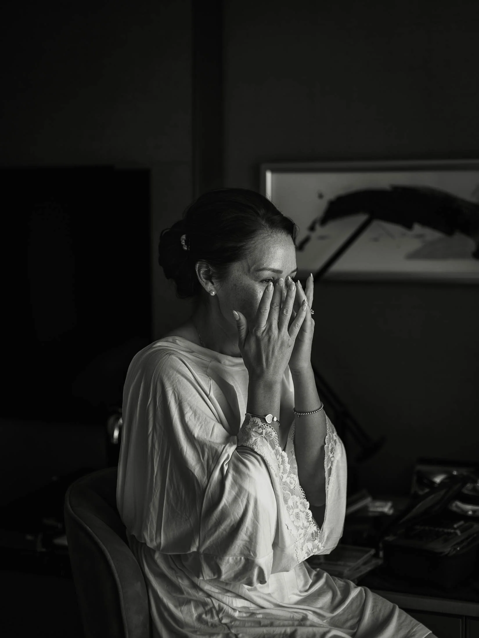 An emotive wedding moment taken during a luxury London wedding day, showing a bride wiping tears from her eyes during her black tie London wedding at The Shard.