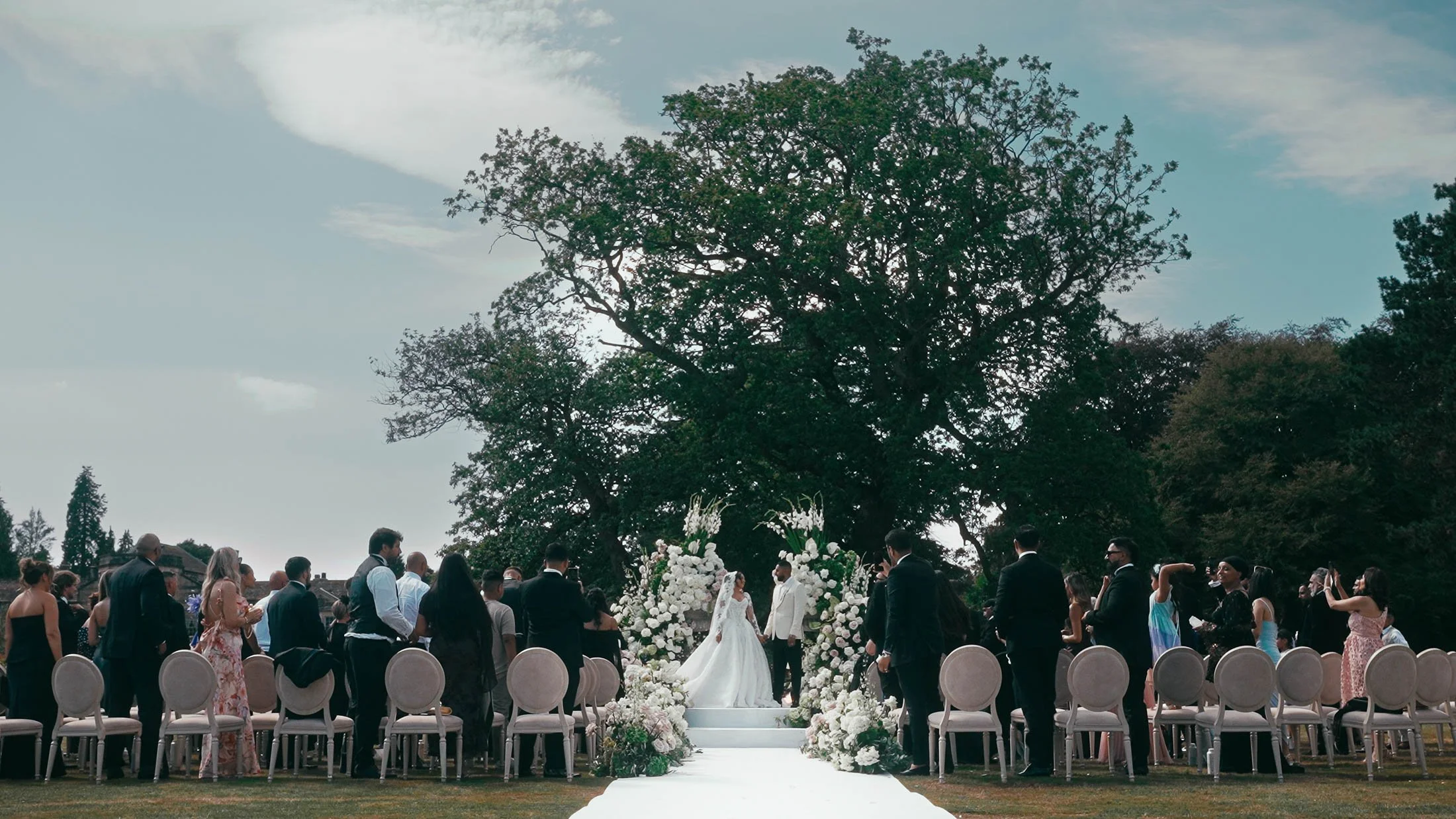 An outdoor wedding ceremony in Yorkshire at Grantley Hall.