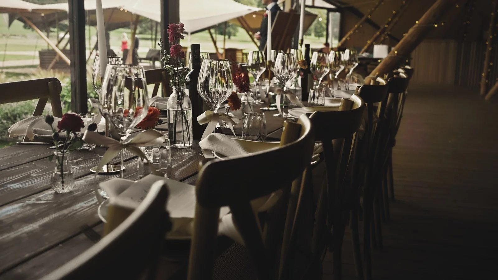 Table decor and glassware during a colourful riverside wedding breakfast.