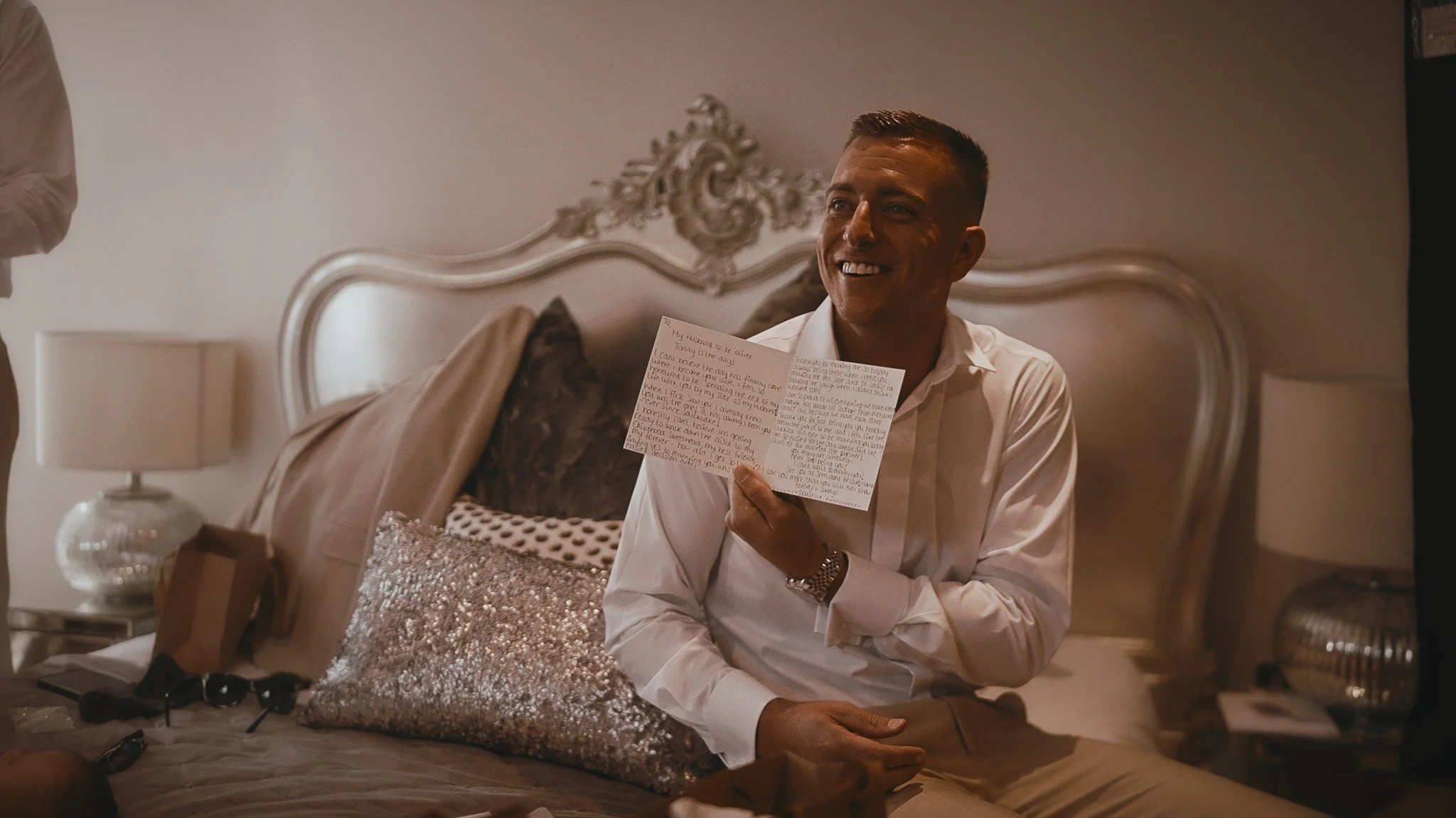 An emotional moment in a wedding film at Vaulty Manor in Essex, as a Groom reads a letter from his bride.