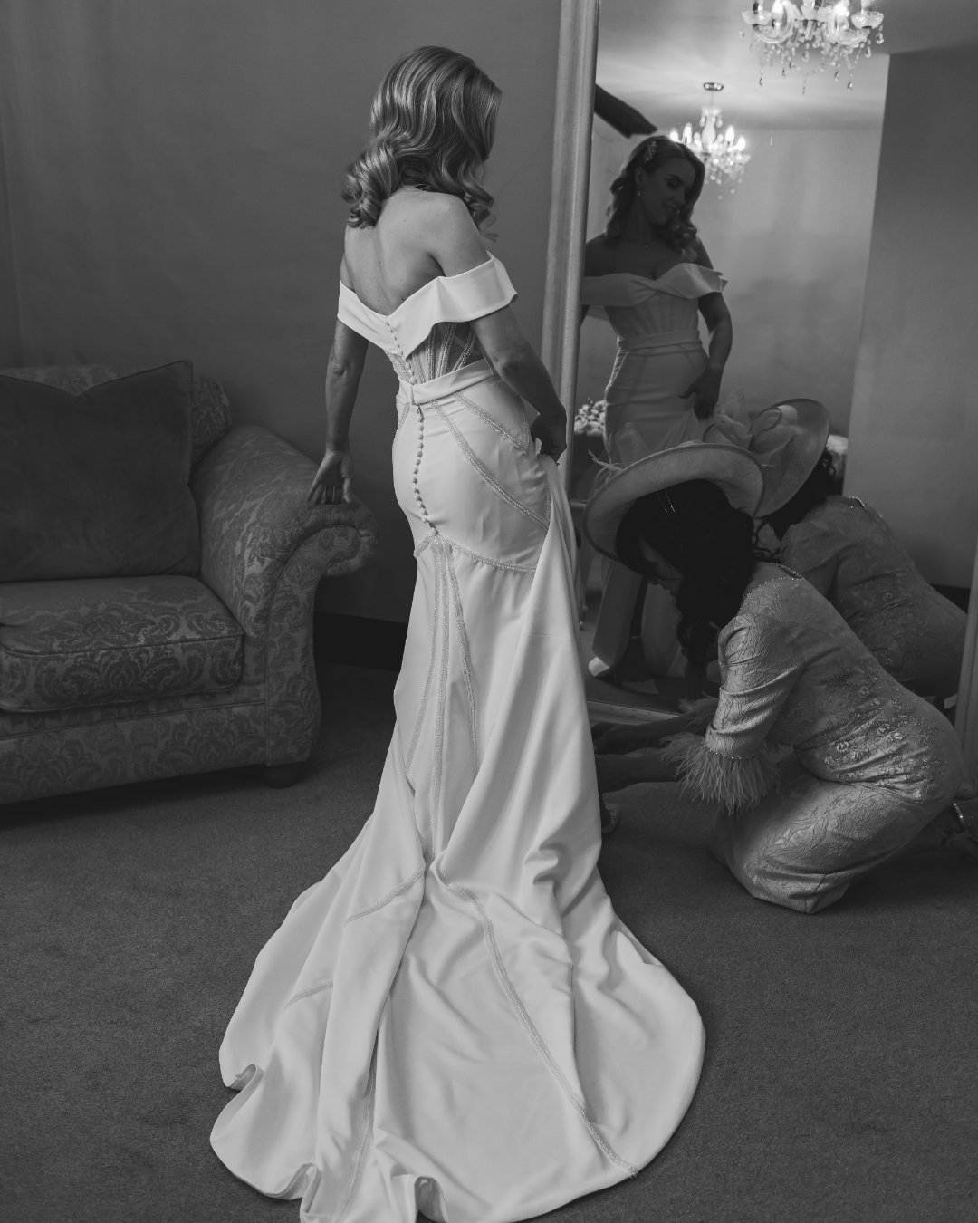 An editorial black and white shot of a bride in her dress, captured by a videography and photography team in the UK.