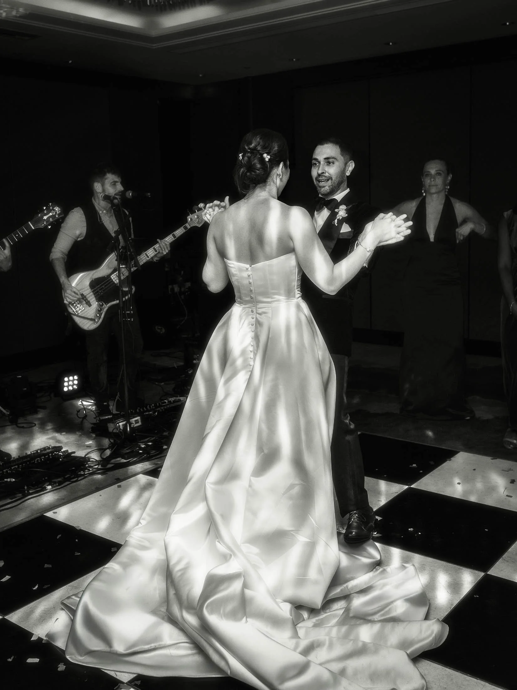 A full length black and white editorial wedding portrait showing a bride and groom sharing their first dance on the 34th story of the Shangri-La hotel at The Shard during their London wedding day.