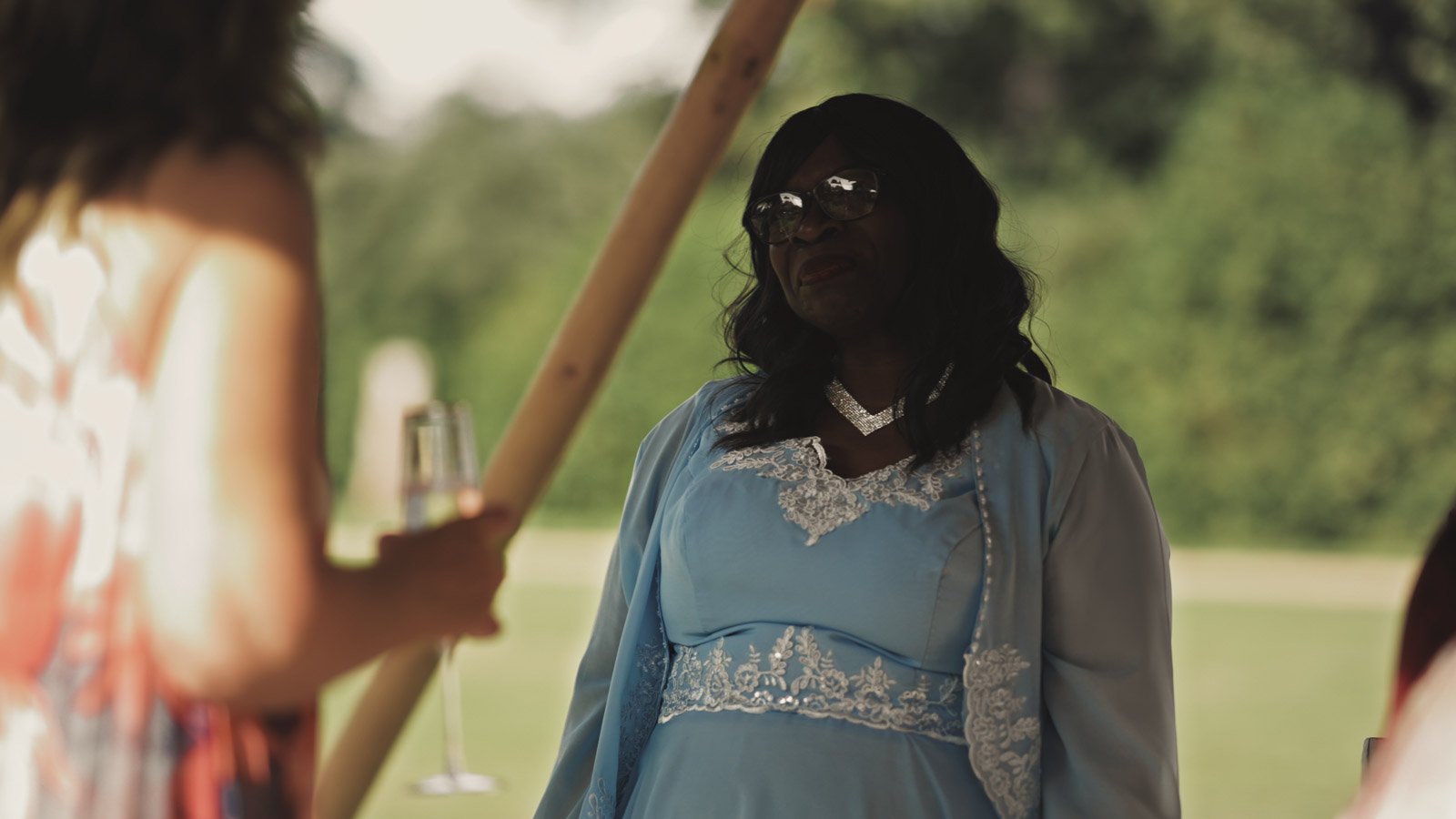 Guests and atmosphere from a colourful riverside wedding with black-tie styling and a marquee party on the Thames.