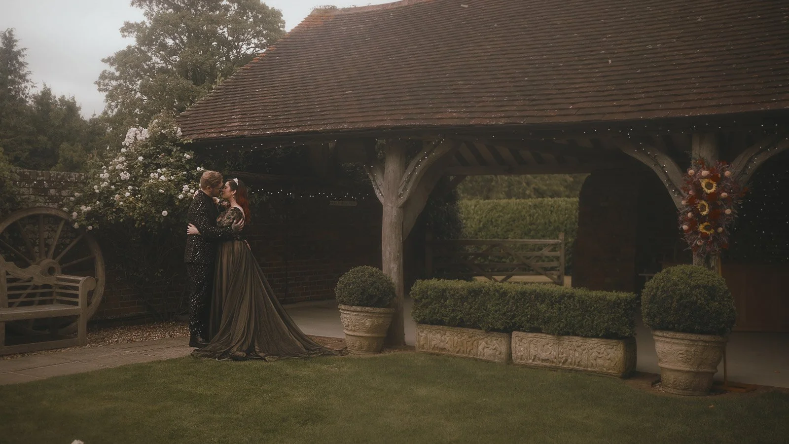 Wide portrait of couple in the courtyard at  Winters Barns for an alternative wedding video