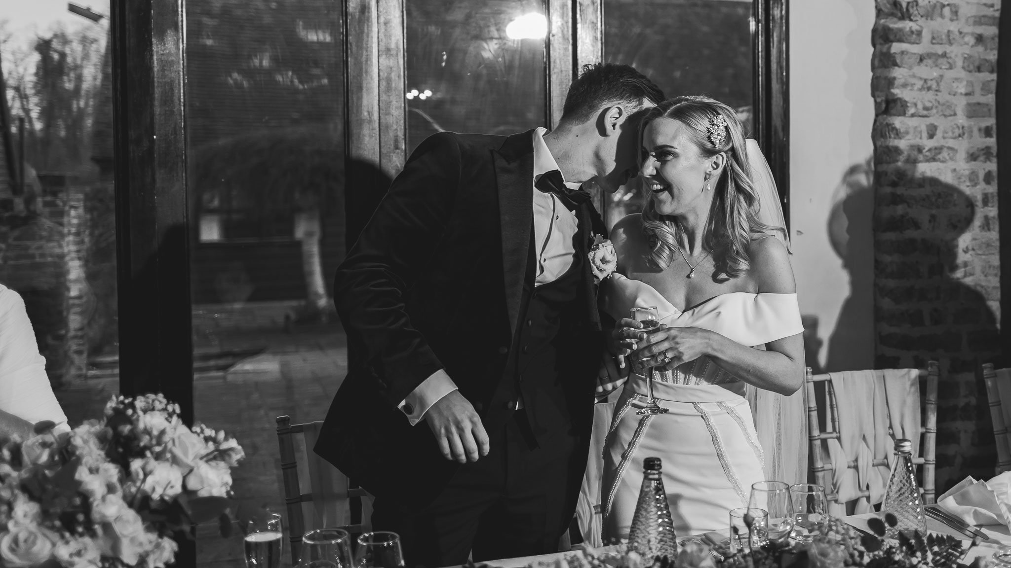 A couple pose during their editorial portrait session at The Leez Priory, guided by a wedding photography and videography team.