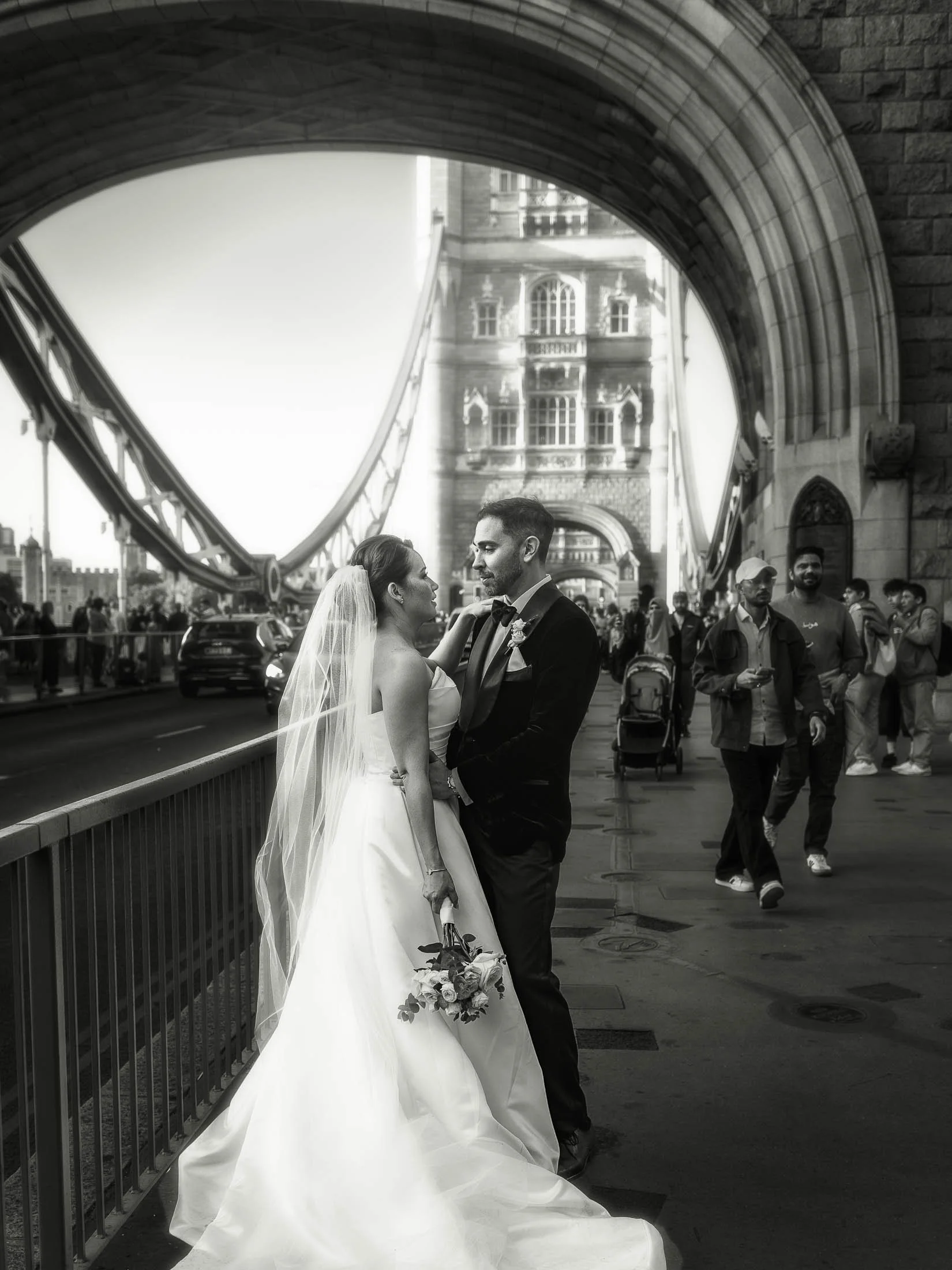 A timeless and romantic London wedding portrait of a bride and groom on Tower Bridge, captured in an editorial black and white style.