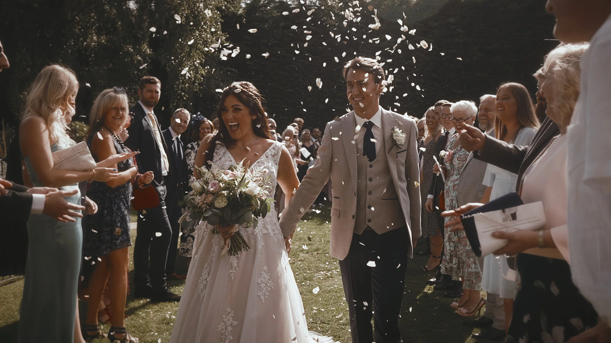 A happy confetti moment as the couple exit their outdoor ceremony in September at Winters Barns.