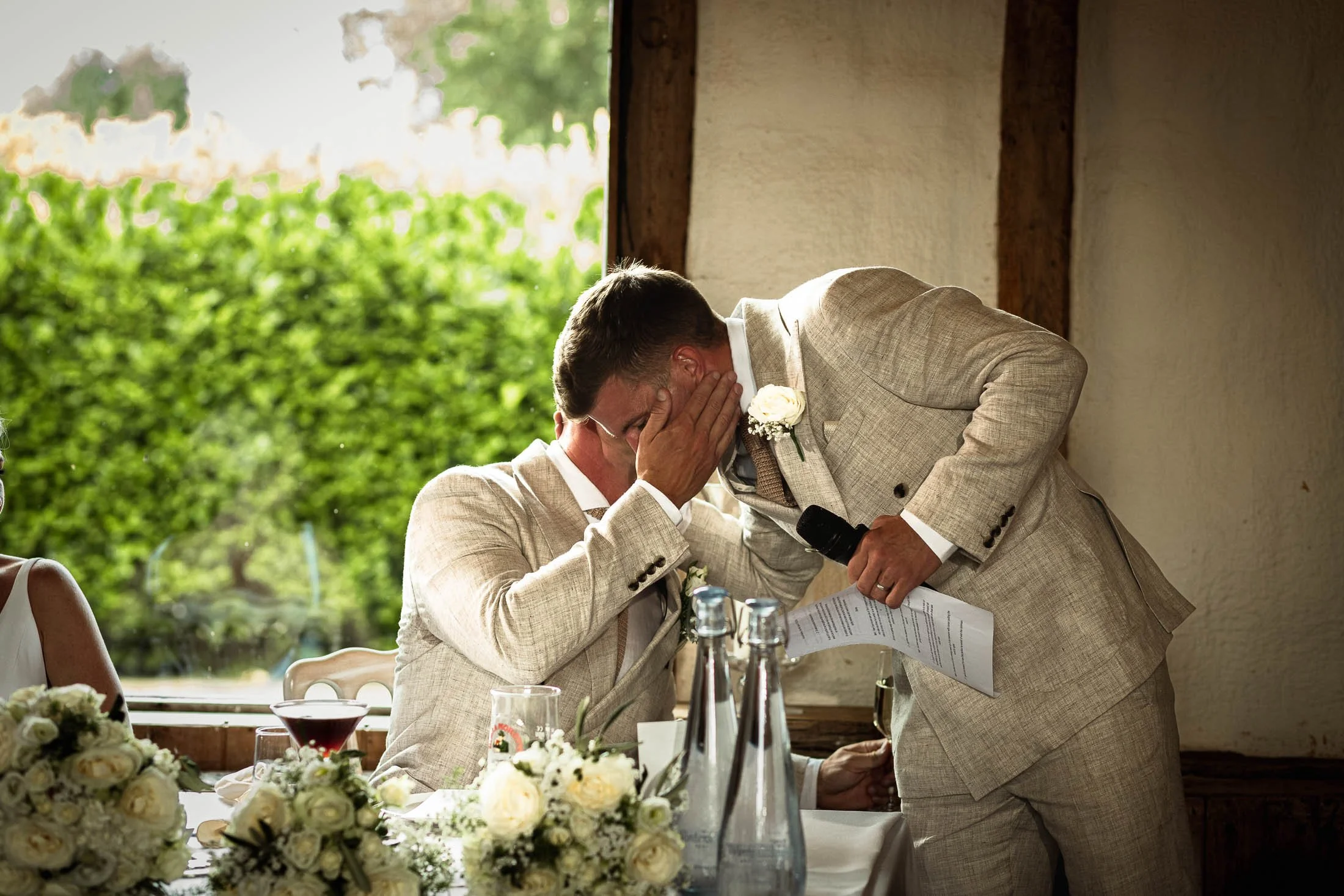 The best Man and Groom hug after the Best Man's speech at Winters Barns, Kent.