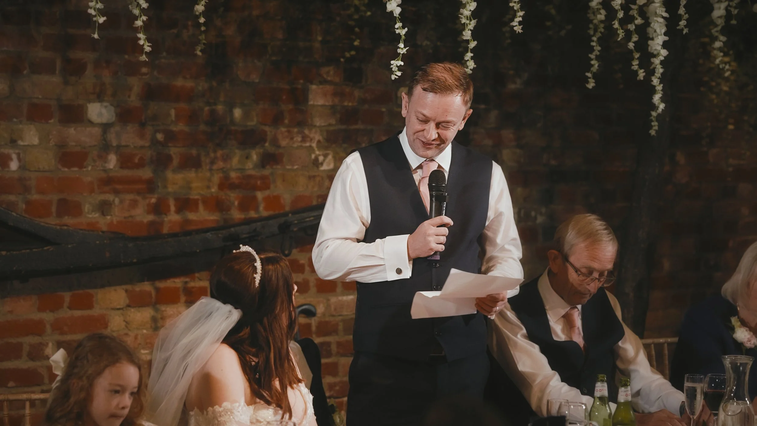 Emotional grooms speech in the Tithe Barn during a Cooling Castle Barn wedding reception in Kent.