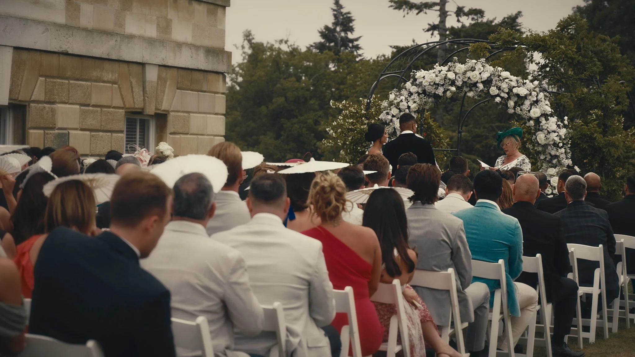 Outdoor wedding ceremony setup on the lawns at Botleys Mansion in Surrey with the house as a refined backdrop.
