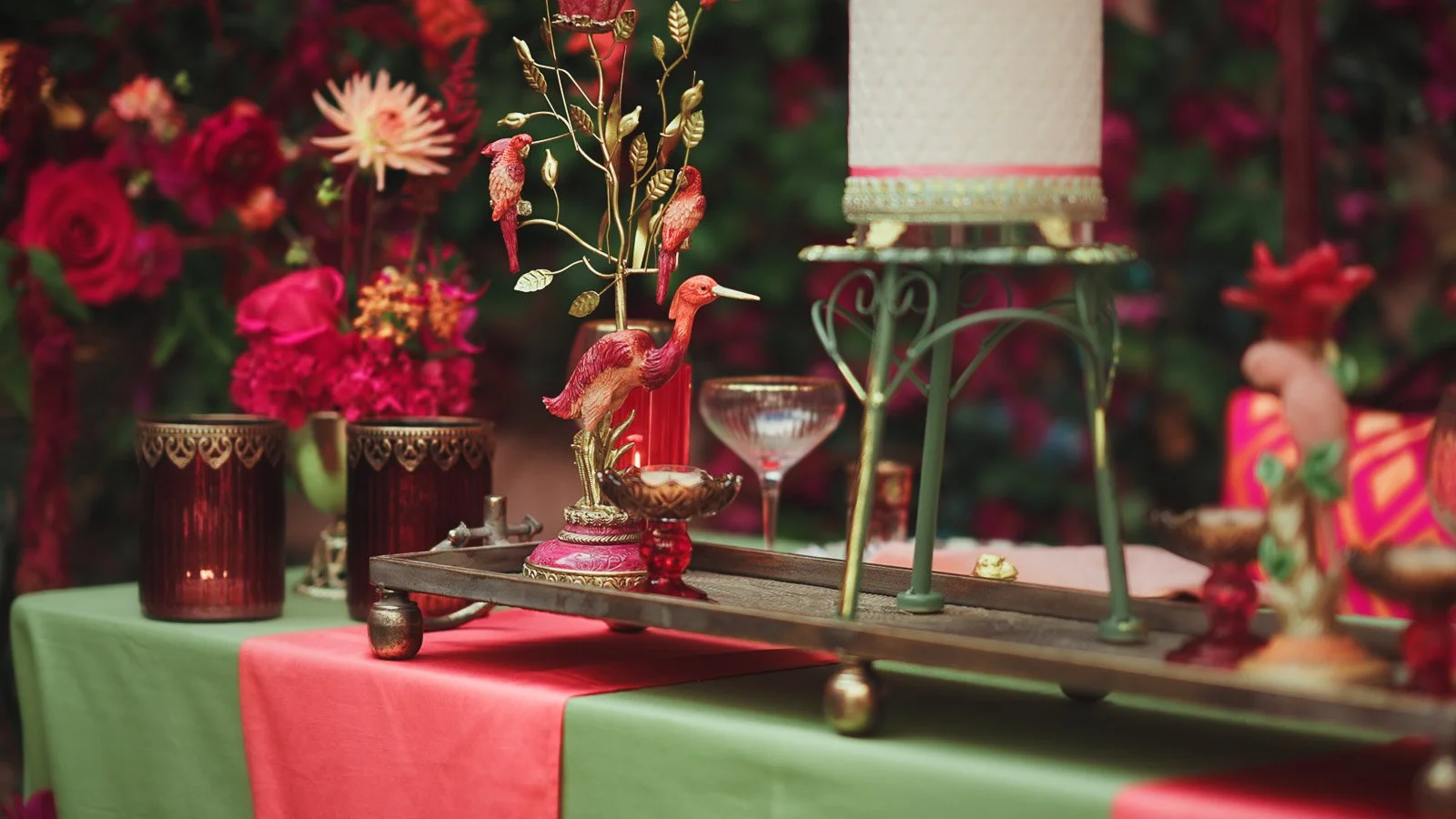 Close-up of pink and red table decor with layered texture and animal figures