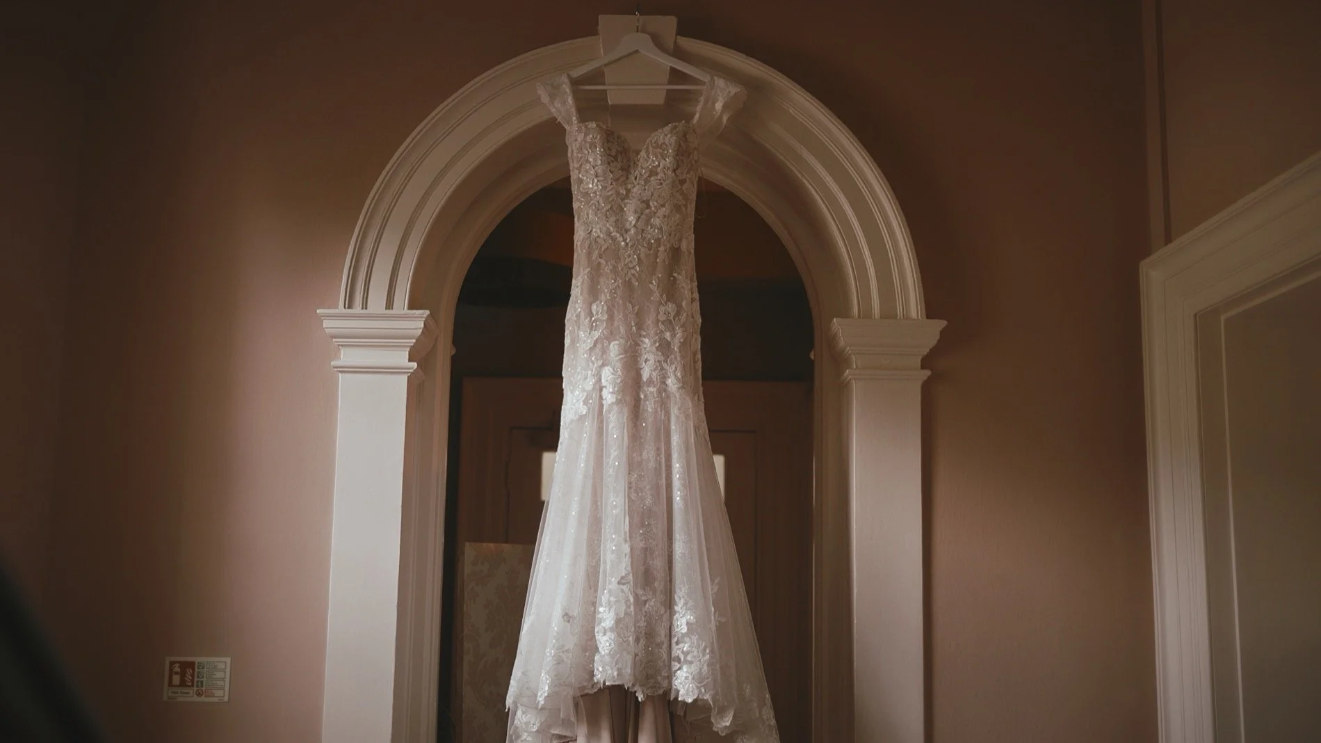 A luxurious wedding dress hangs in an archway at the Orangery, Maidstone.