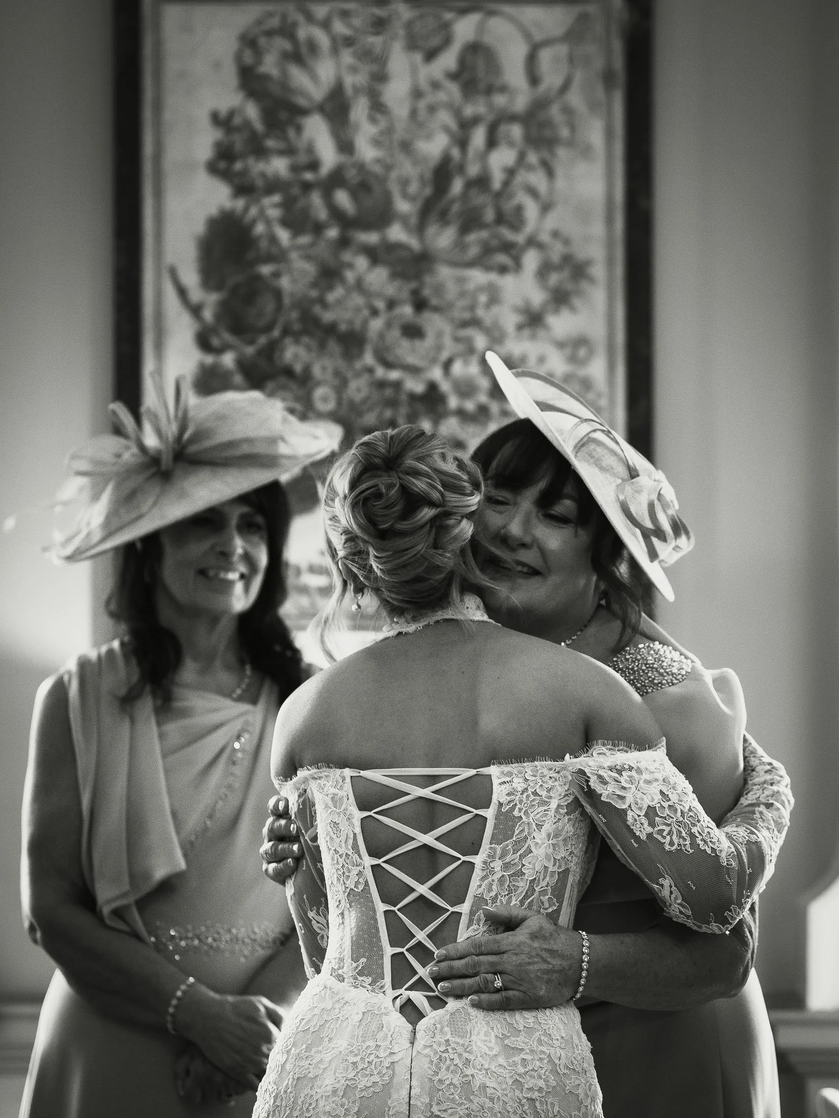 A bride embraces her mother during wedding preparations at The Orangery Maidstone, captured in an editorial styl by a photo and video team.