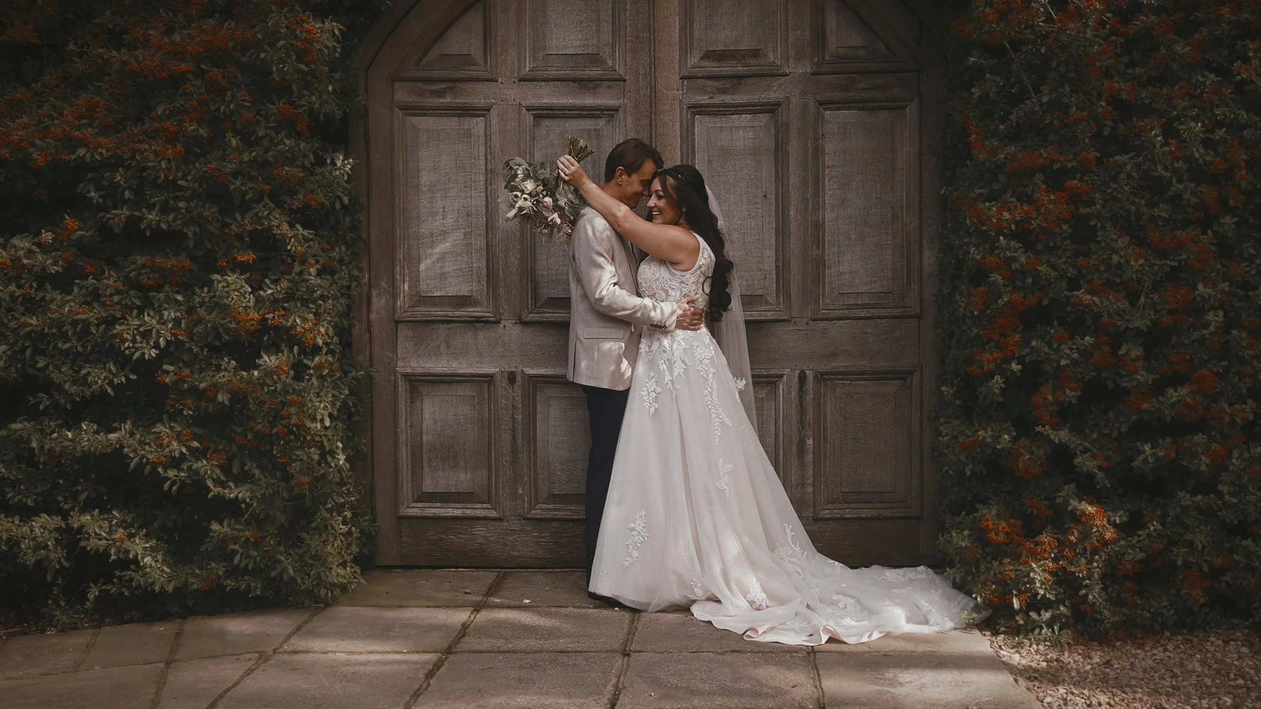 An editorial pose by a couple standing by the large barn doors at Winters Barns.