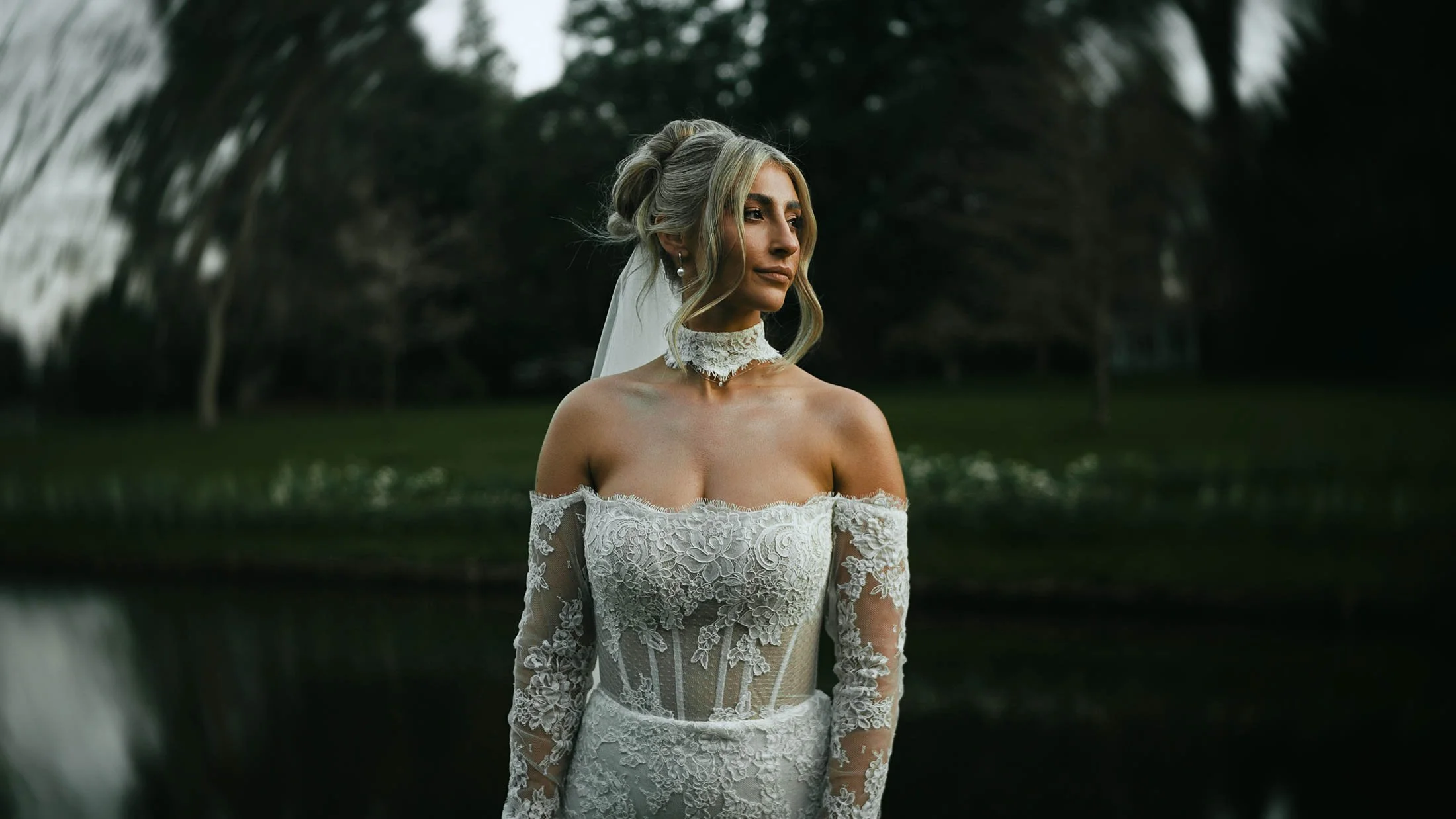 A cinematic and editorial-style bridal portrait outdoors during golden hour, taken from a storytelling wedding film captured and told in the UK.