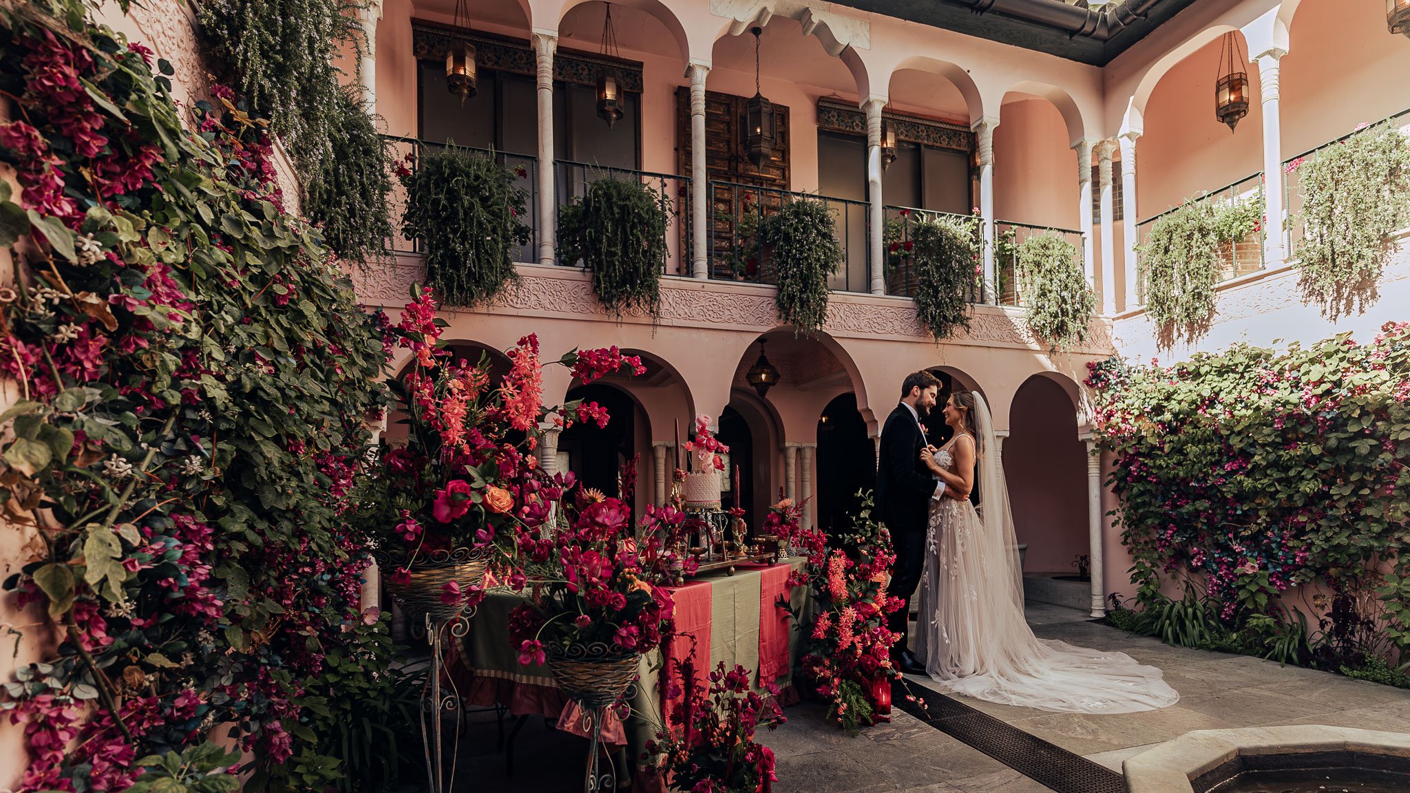 A luxury wedding reception at Port Lympne Hotel with a bright pink theme, captured by videographer Luke Batchelor productions