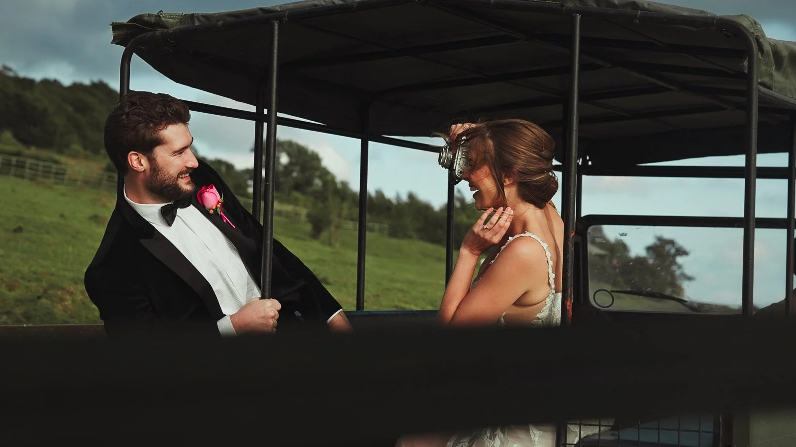 A fine art wedding moment as the bride takes a picture of the groom using an old vintage camera.