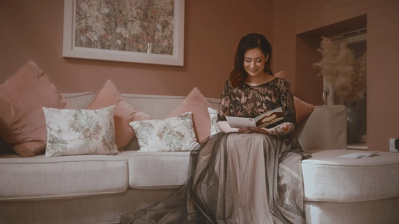 Close-up of tattooed hands holding a wedding letter before the ceremony