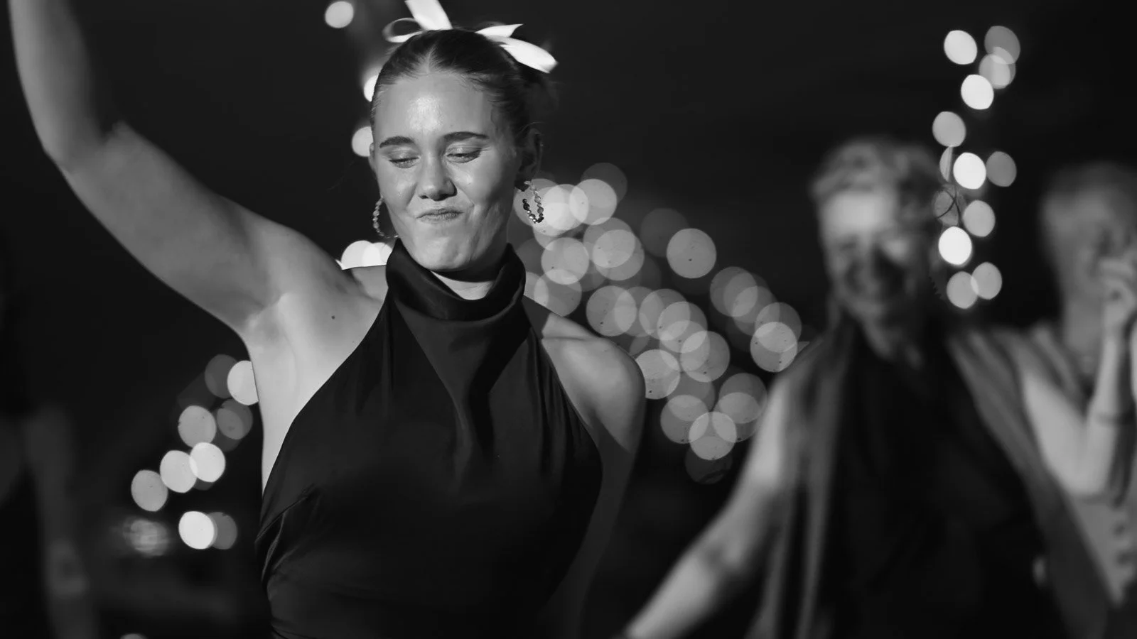 Editorial-style wedding photography from a colourful riverside celebration with bold florals and a marquee reception.