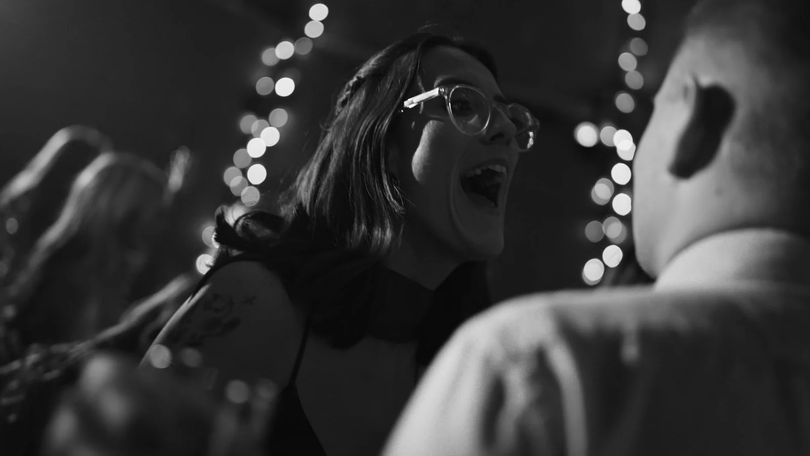 Editorial-style wedding photography from a colourful riverside celebration with bold florals and a marquee reception.