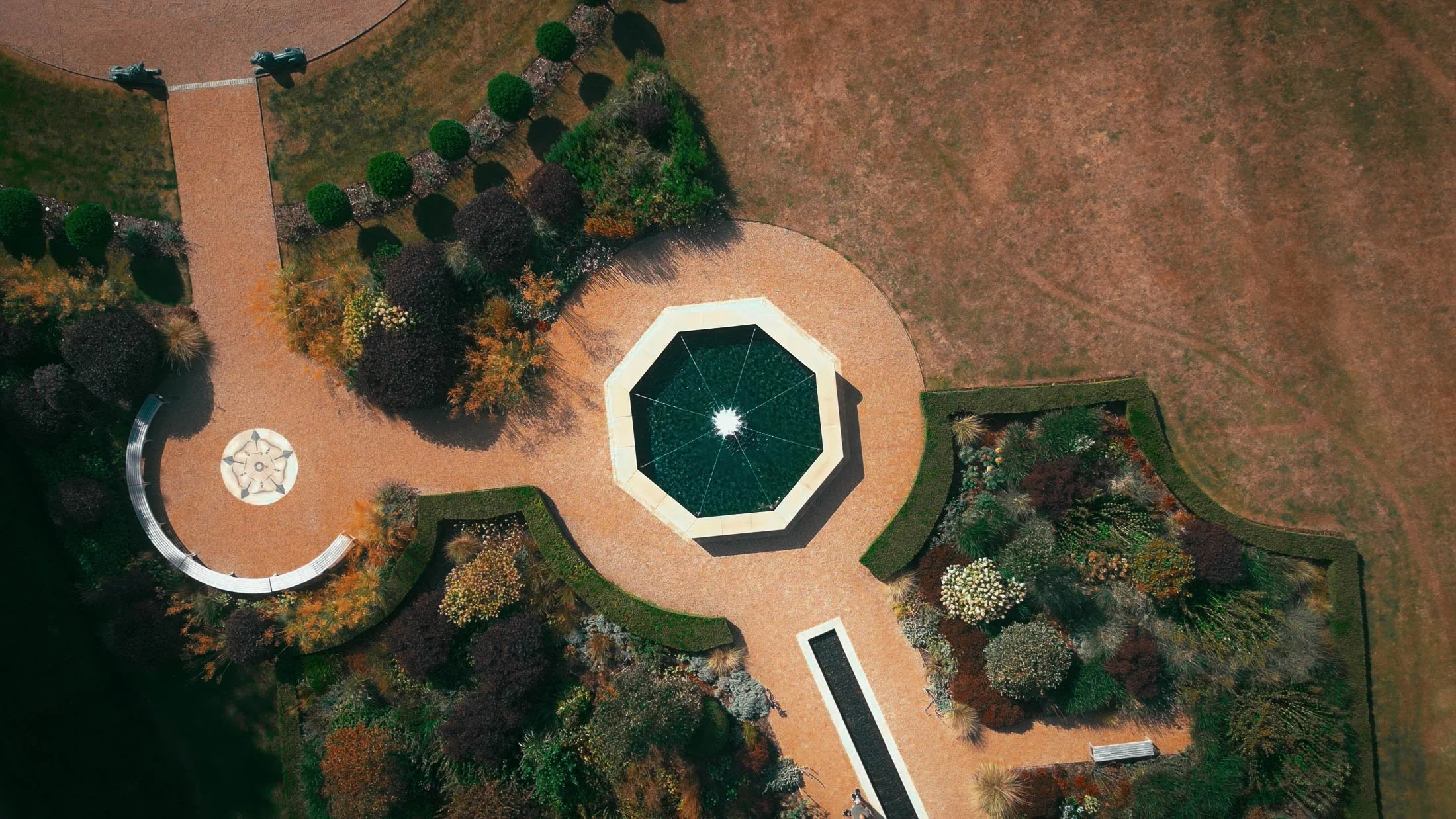 A Grantley Hall wedding videography drone shot pointing straight down at a fountain at the front of the Yorkshire venue.