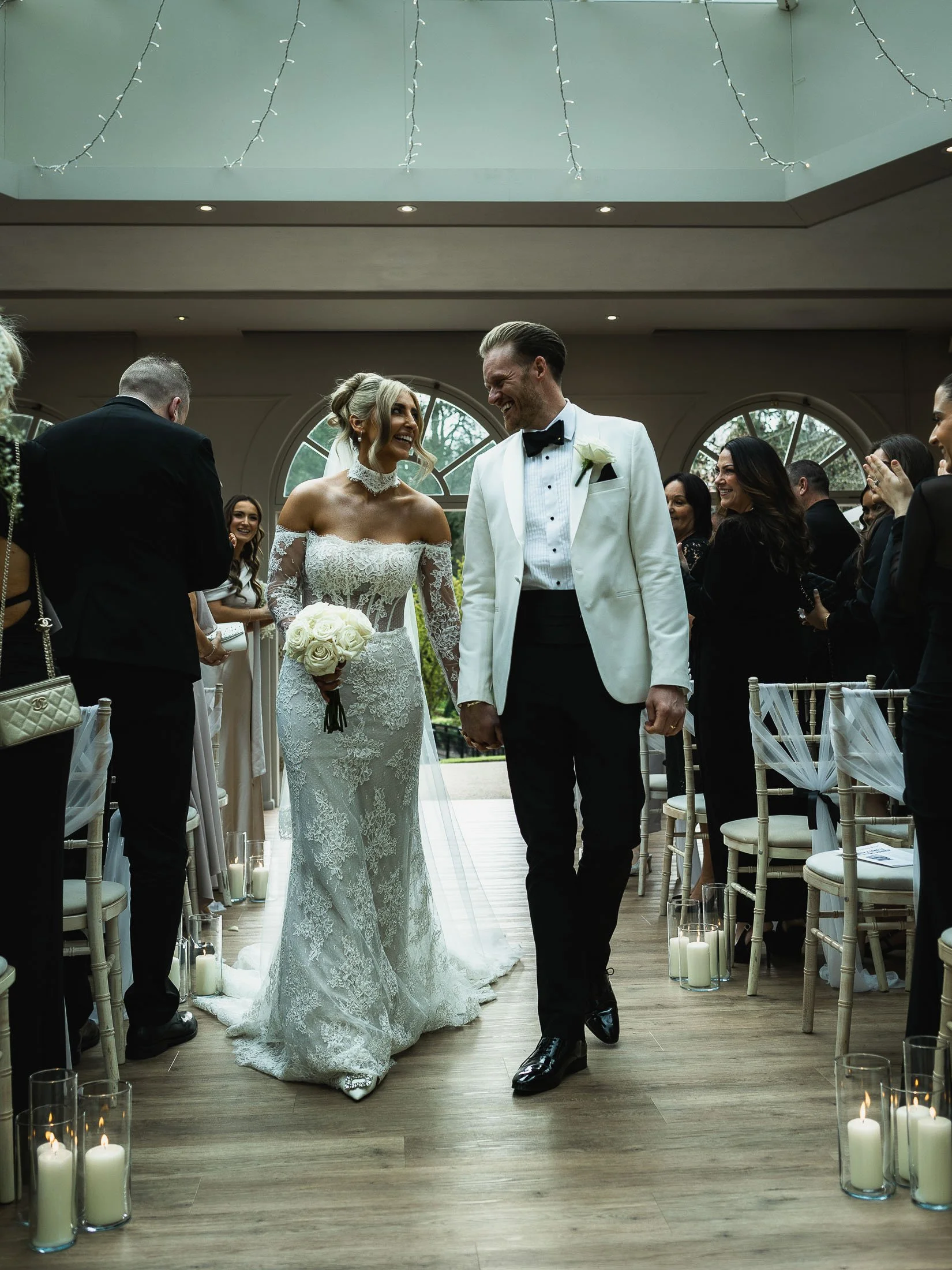 Couple exit their wedding ceremony at the Orangery Maidstone during an editorial Kent wedding.