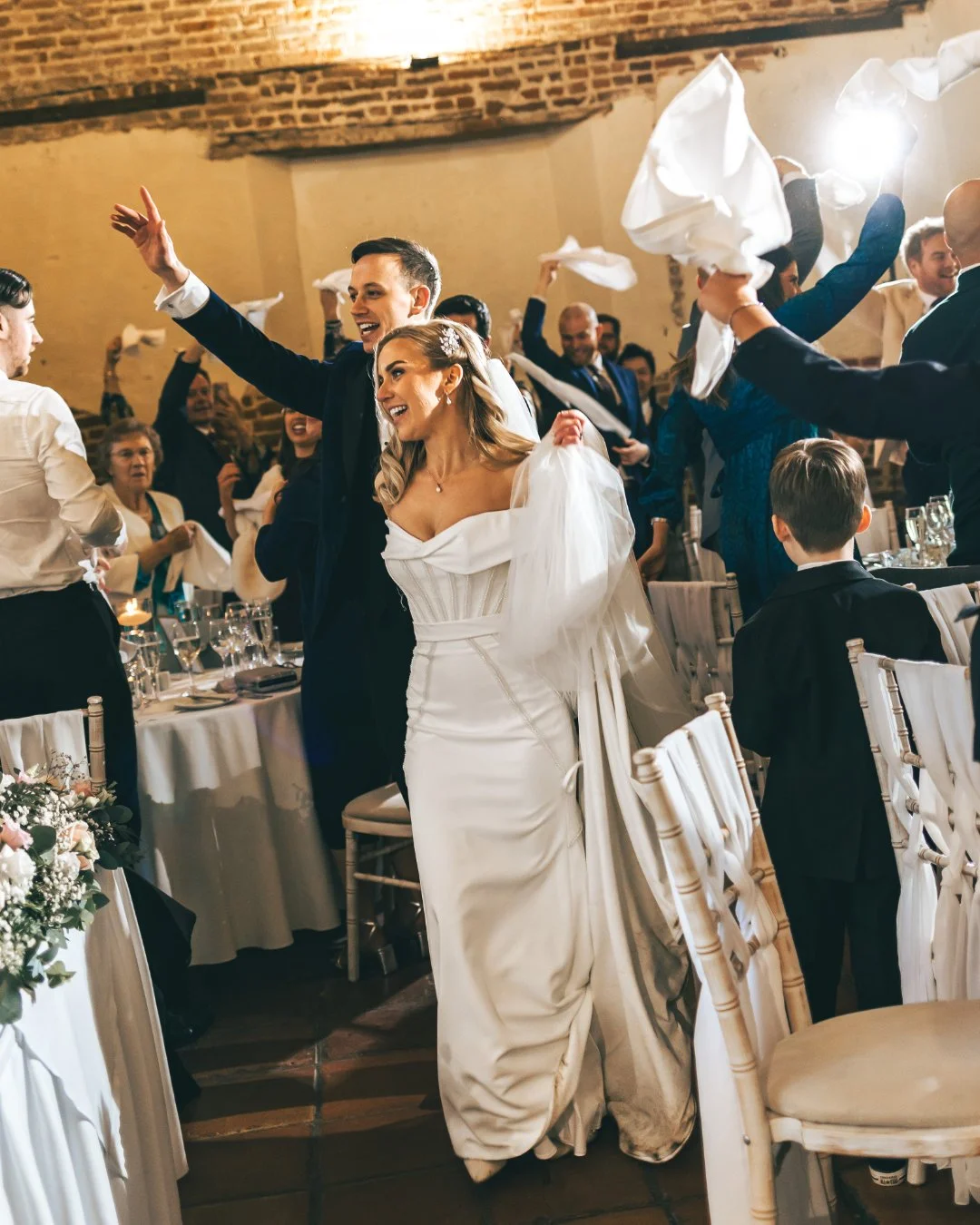 An emotional wedding moment as a couple are announced to their wedding guests- captured by a luxury photo and video team.