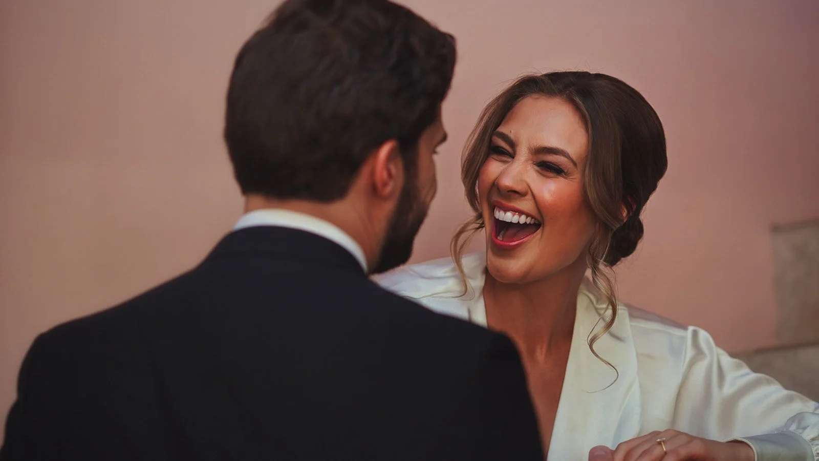 The bride laughs at the groom in an intimate wedding moment from their editorial wedding film.