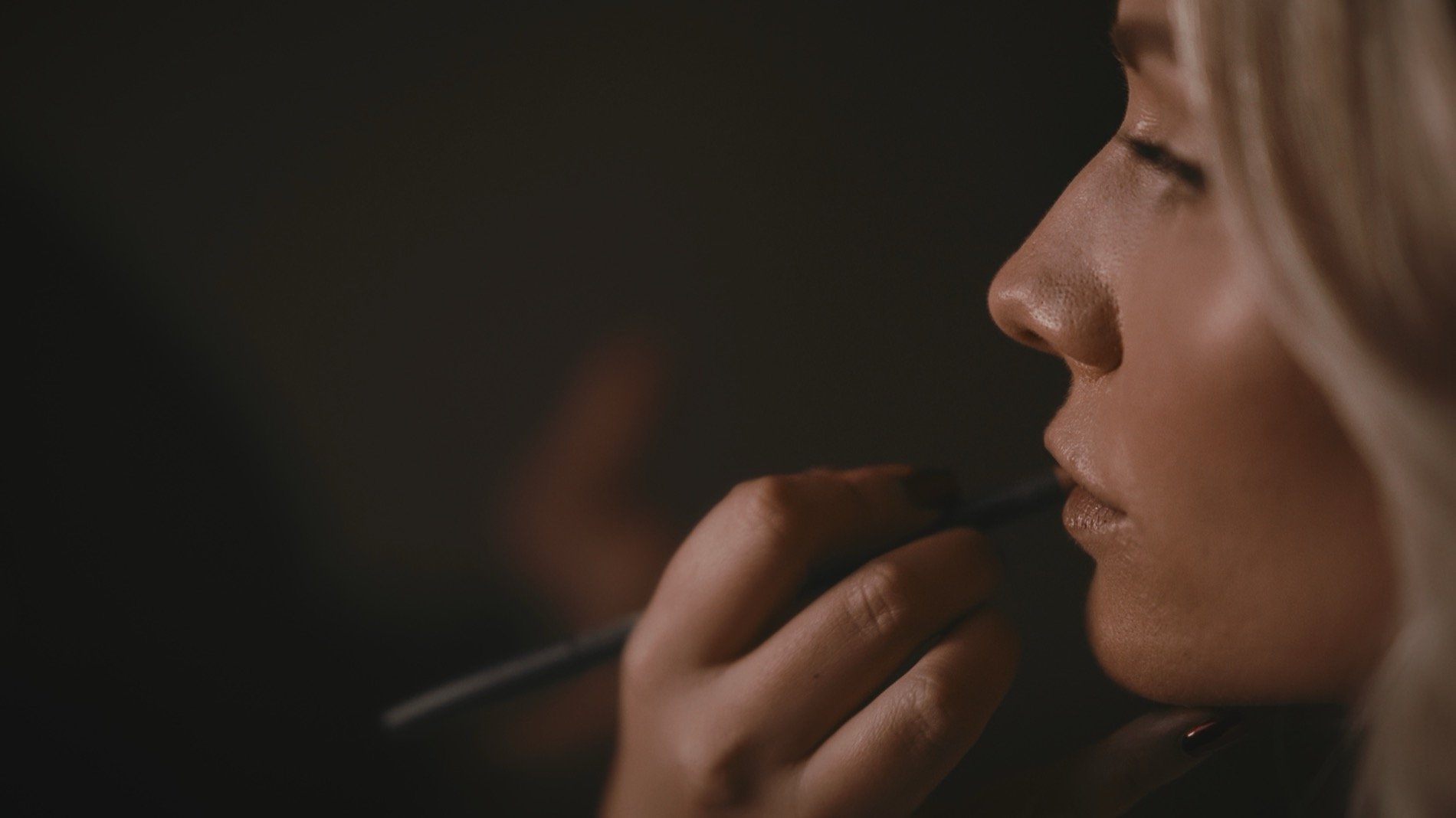 A close up shot of a bride having her make up applied in the Wisteria Suite at The orangery in Maidstone, Kent.