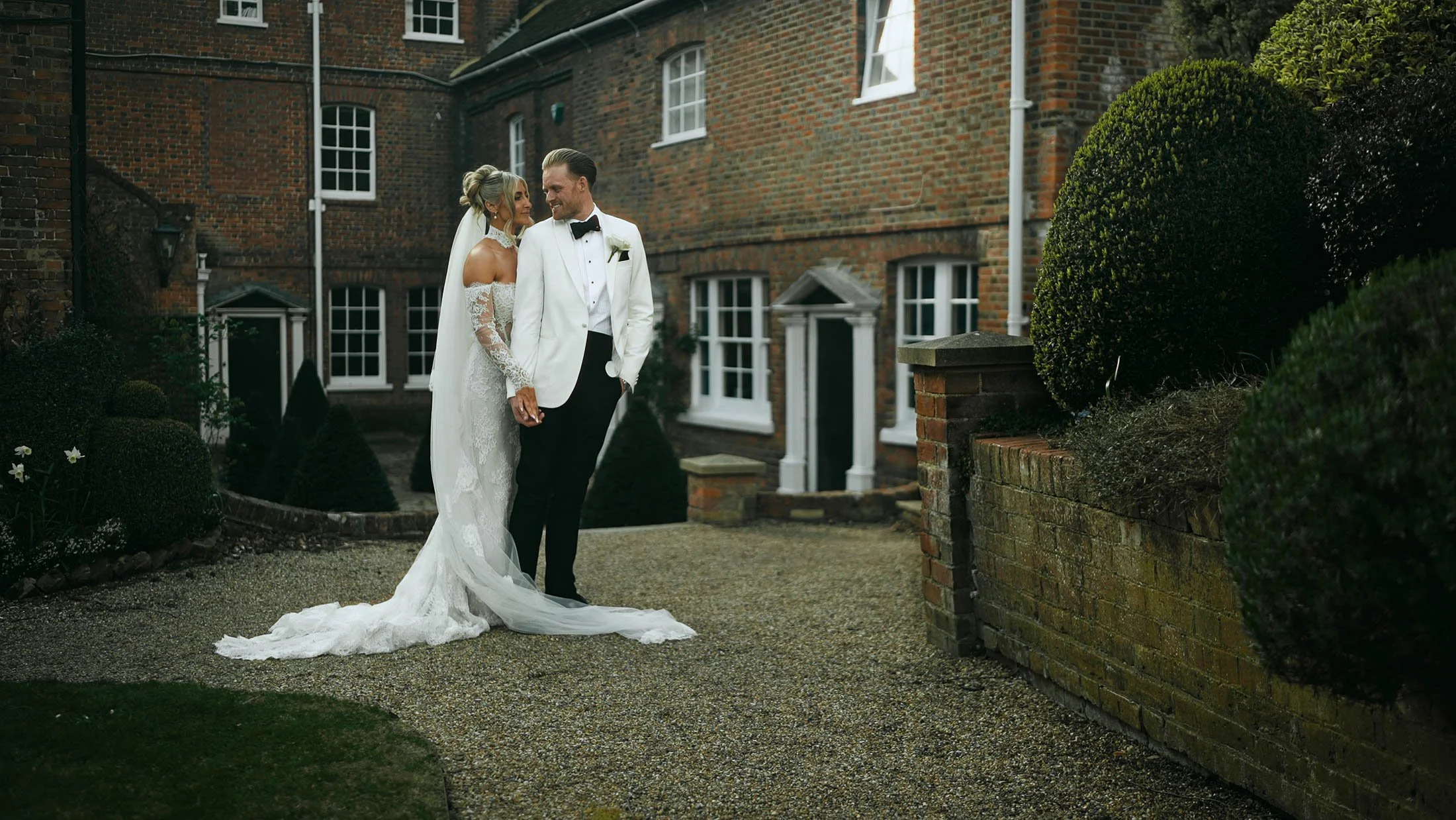 A wide shot of a couple posing for a cinematic moment in their storytelling wedding film in the UK.