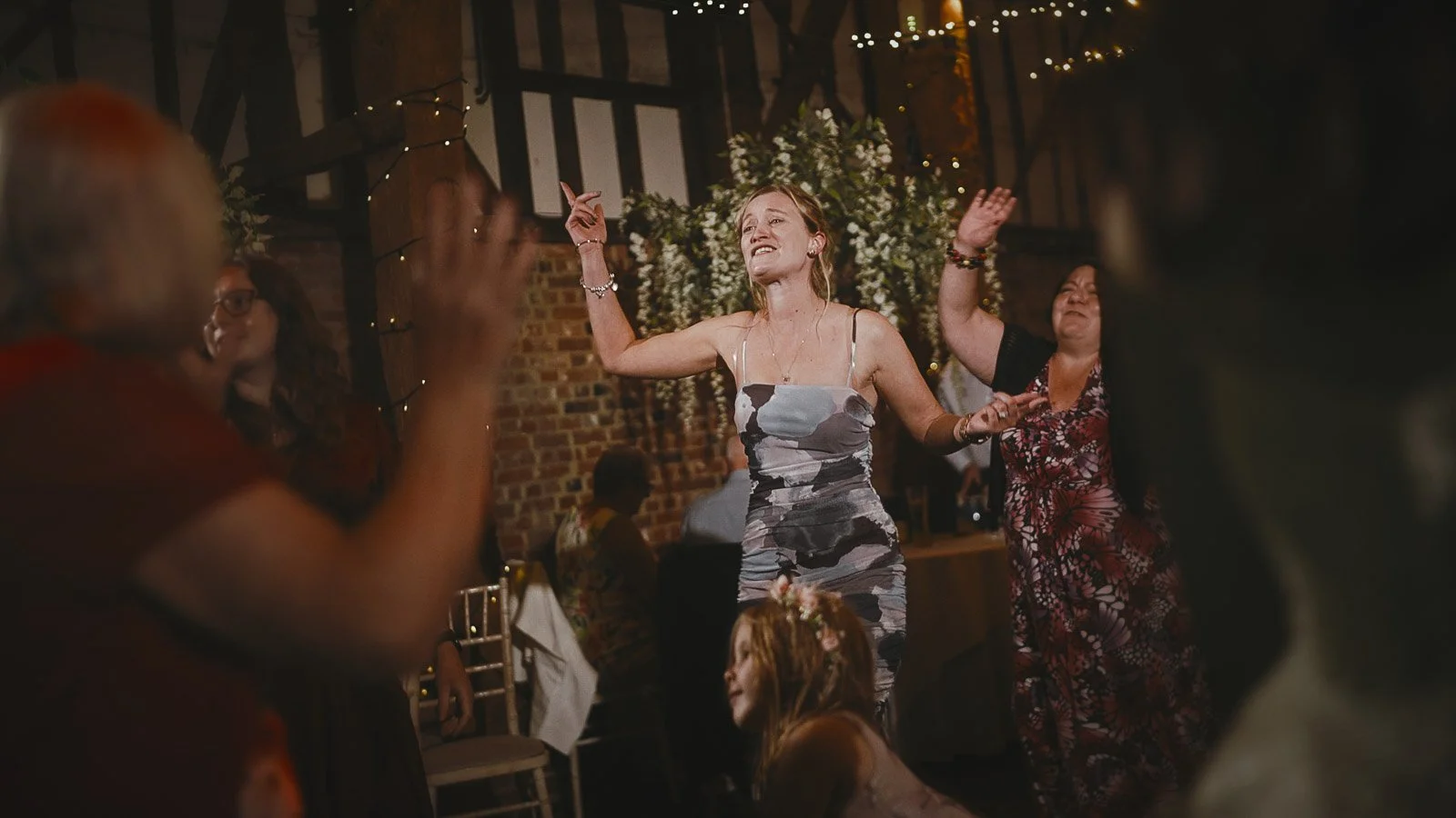 High-energy dancing and celebration during an after party at Cooling Castle Barn wedding venue.